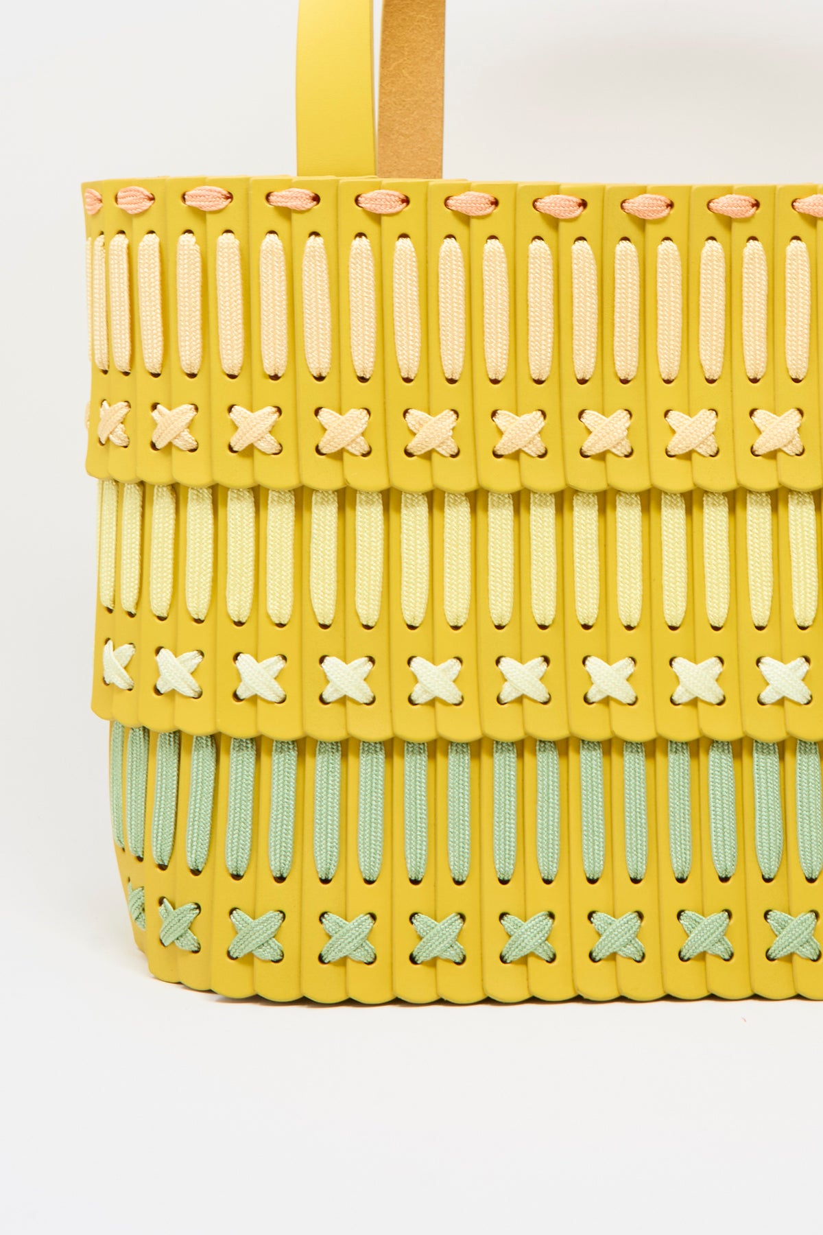 Hatori Leather Tote 198 Artist Edition with Holly Coulis in Yellow, a handcrafted bag made of yellow leather segments laced together with pink, cream, lime green, and white cords.