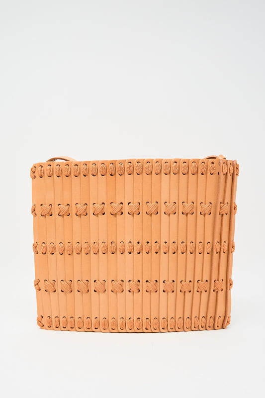 The Hatori Leather Crossbody 48 in Natural with Natural Lace is a rectangular, tan woven bag featuring vertical strips, horizontal stitching, and an adjustable shoulder strap, displayed on a plain white background.
