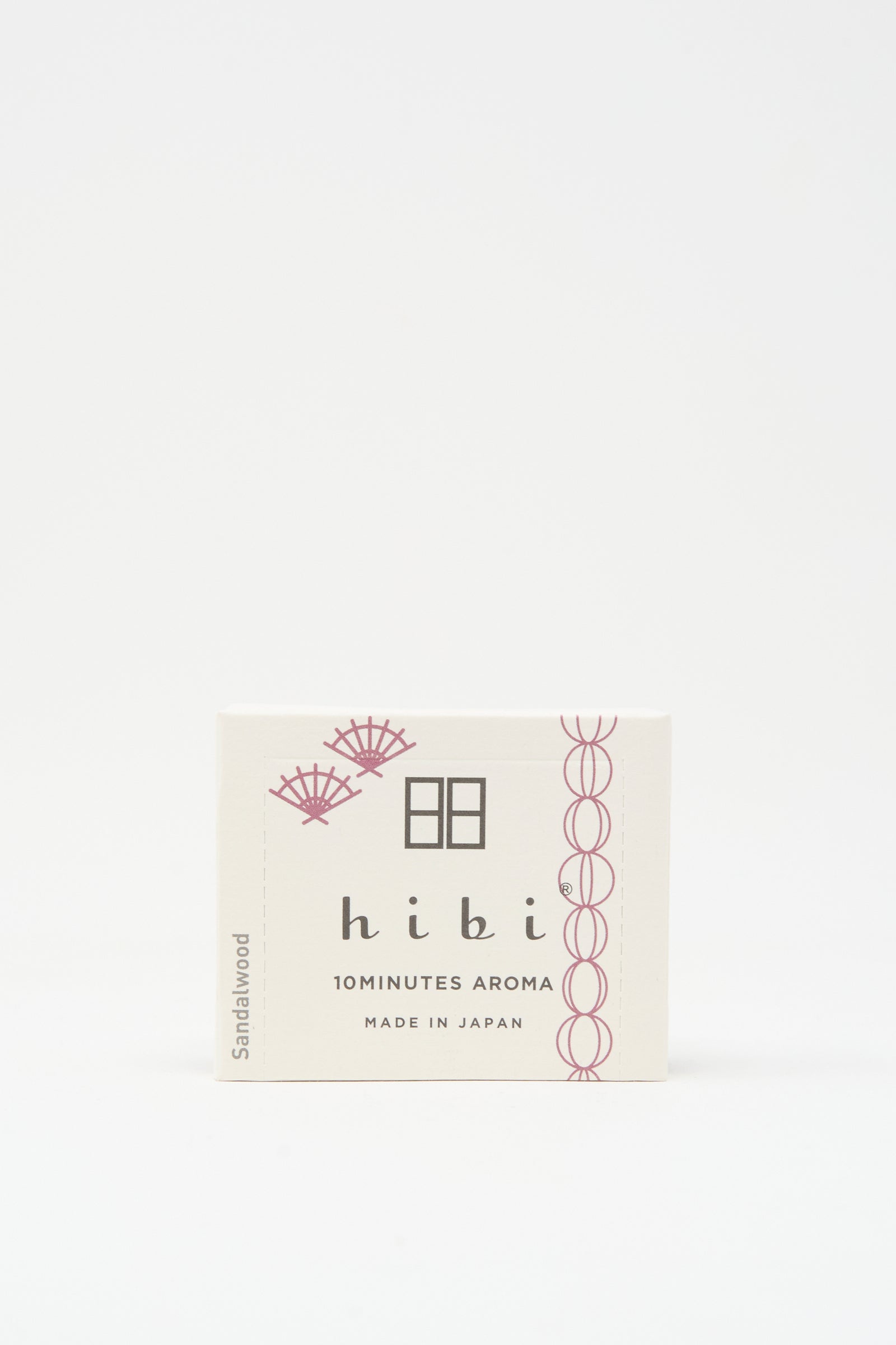 A white Hibi Incense Matches box labeled "10 MINUTES AROMA, MADE IN JAPAN" with a sandalwood scent and subtle pink accents, containing handcrafted Japanese matches.