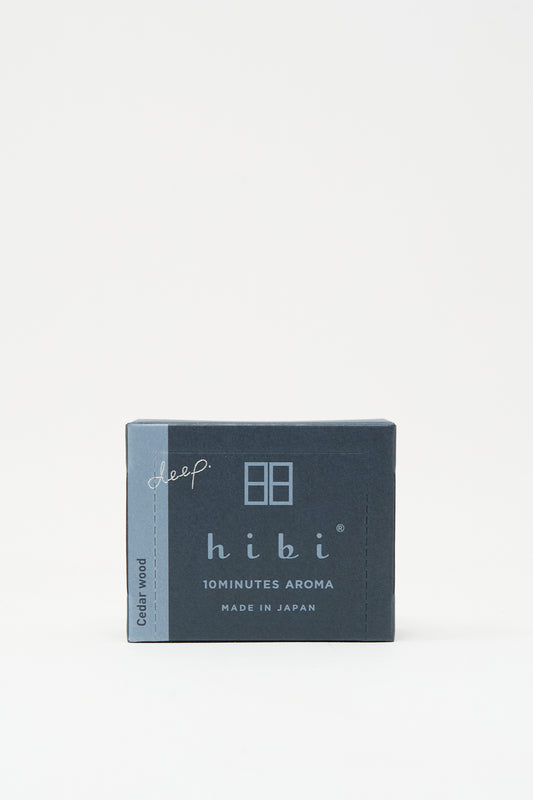 A small navy blue box labeled "Cedarwood Incense Matches" from Hibi, featuring Japanese incense matches with a cedar scent and "Made in Japan" below the product name.