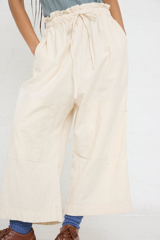Woman wearing Azumadaki Cotton Quilt Pant in Ivory with drawstring waist, partial view, from Ichi Antiquités.