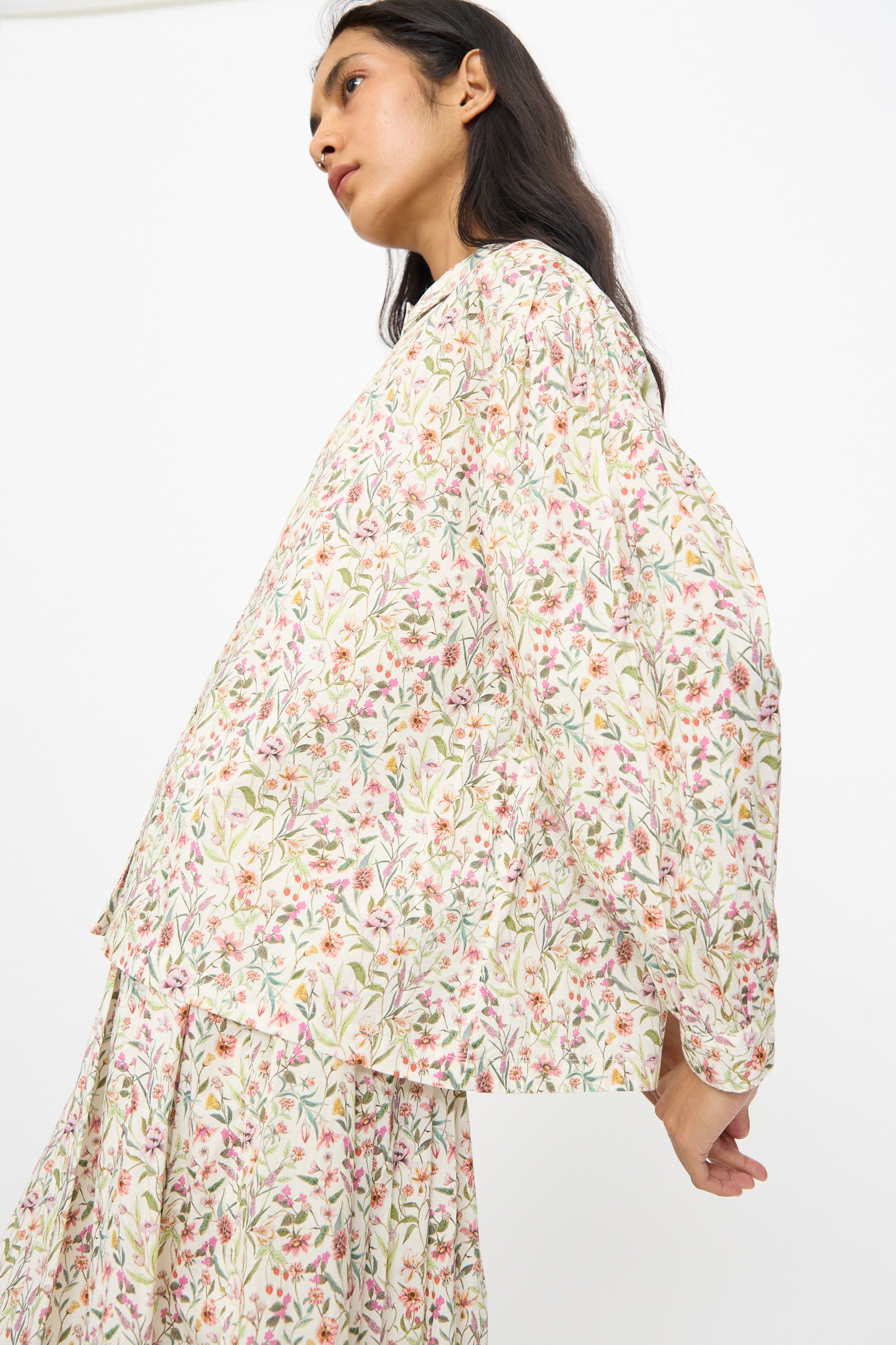 A woman wears the Ichi Antiquités Cotton Liberty Shirt in Flower Print with a matching skirt, standing against a plain white background.
