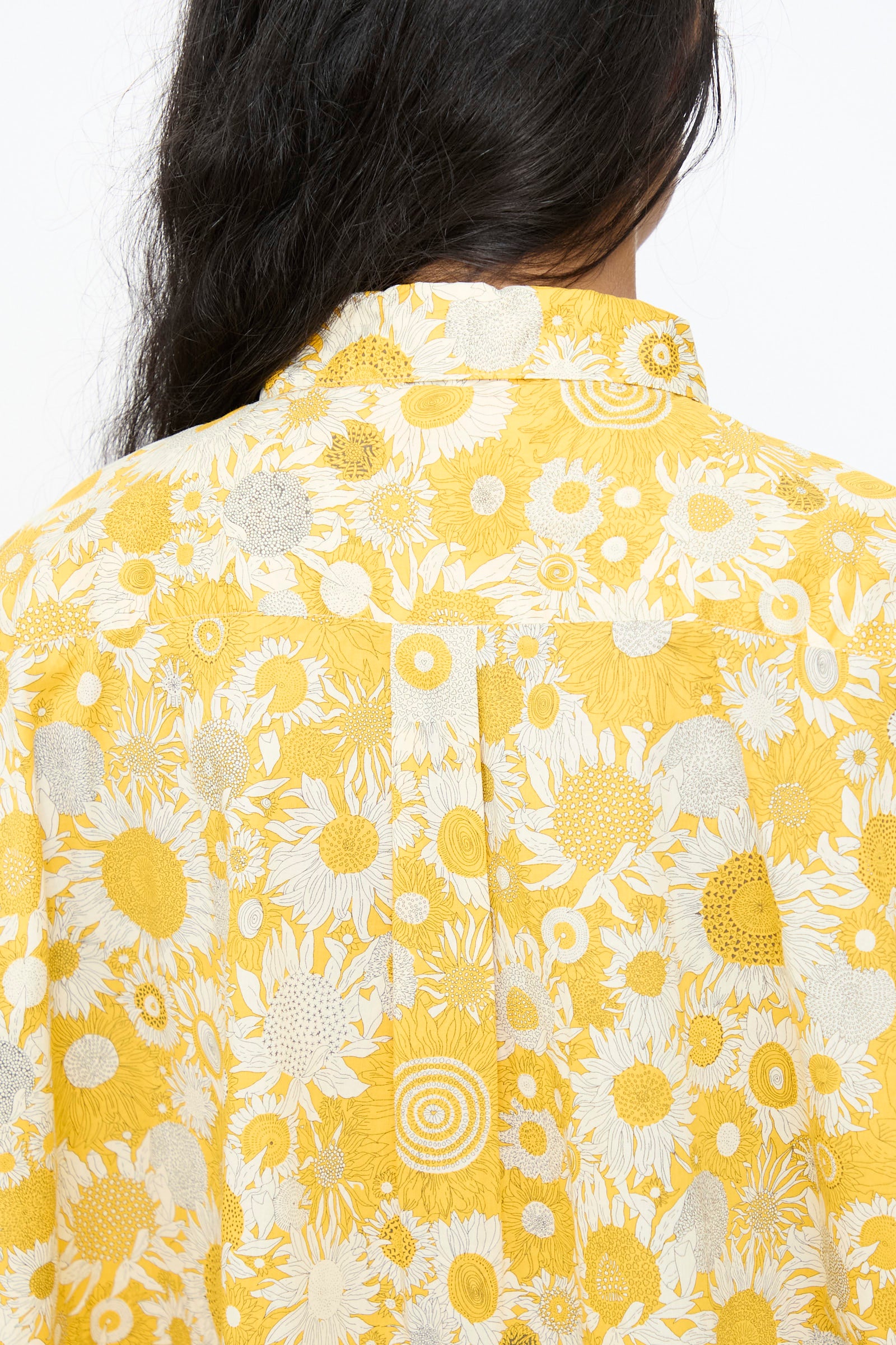 A person with long dark hair is shown from behind, wearing the Ichi Antiquités Cotton Liberty Shirt in Yellow.