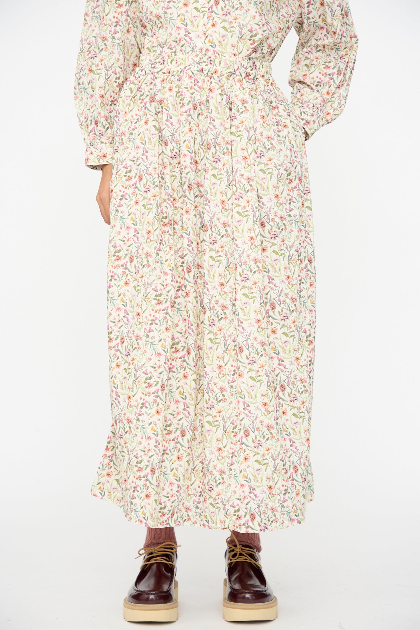 A person wearing the Ichi Antiquités Cotton Liberty Skirt in Flower Print, paired with maroon platform lace-up shoes.
