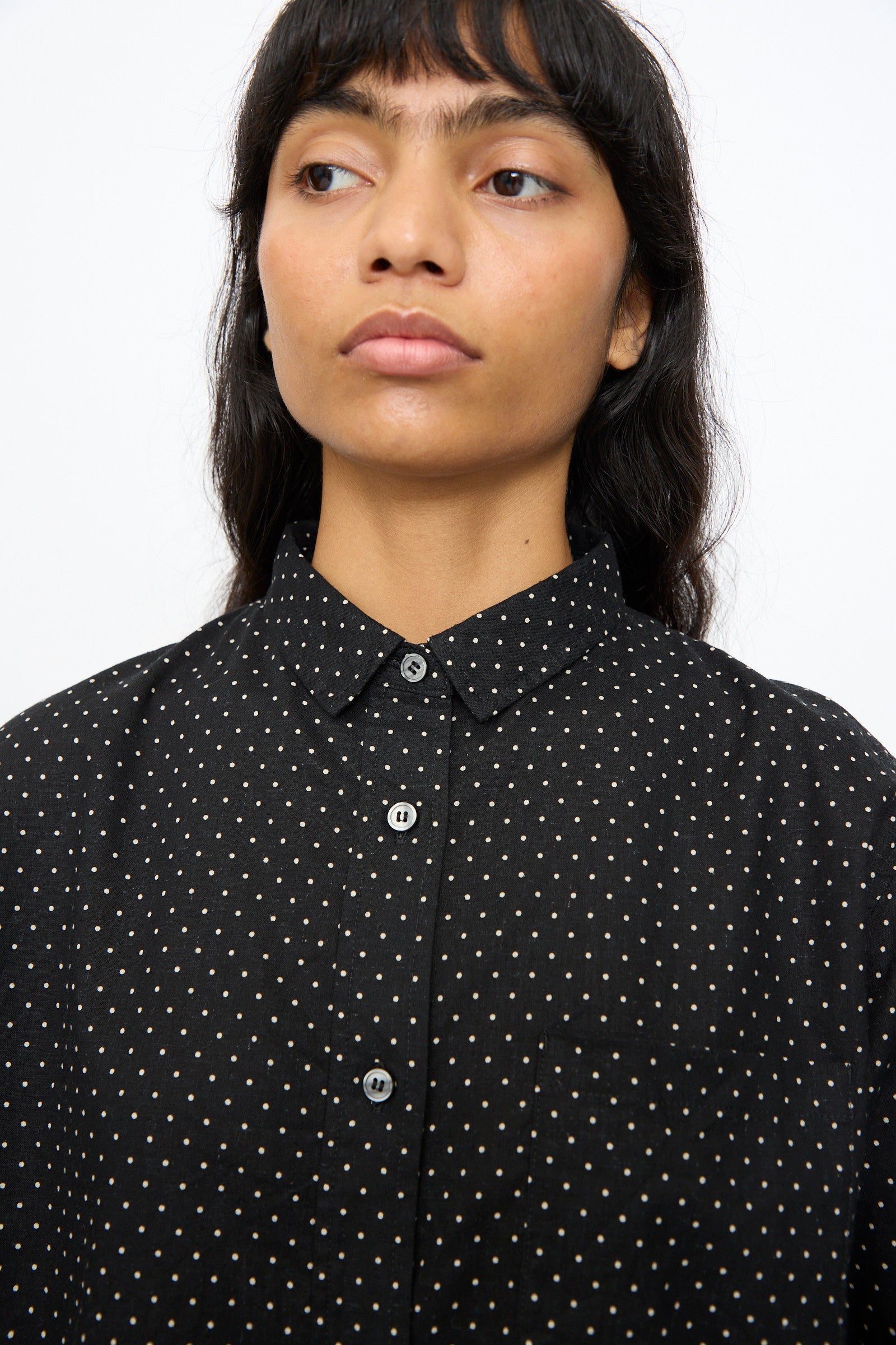 A person with long dark hair wears the Ichi Antiquités Cotton Linen Dot Shirt in Black, looking slightly to the side against a plain background.