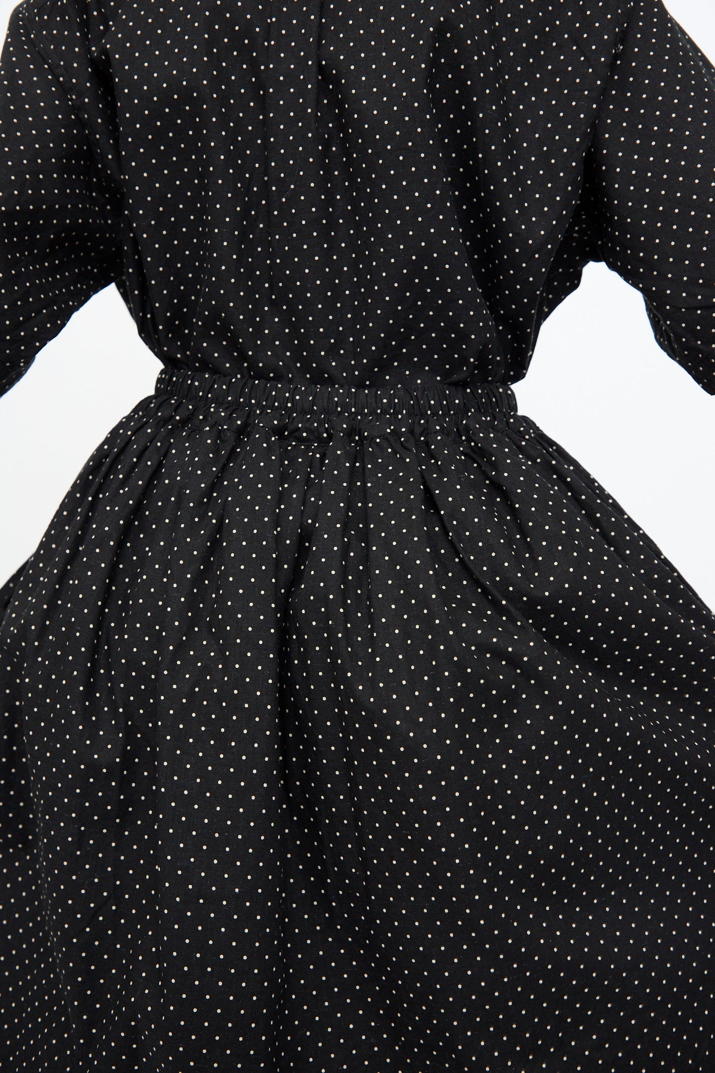 The Cotton Linen Dot Skirt in Black by Ichi Antiquités features white polka dots and a flowing silhouette, shown from the back with a gathered, elasticized waist.