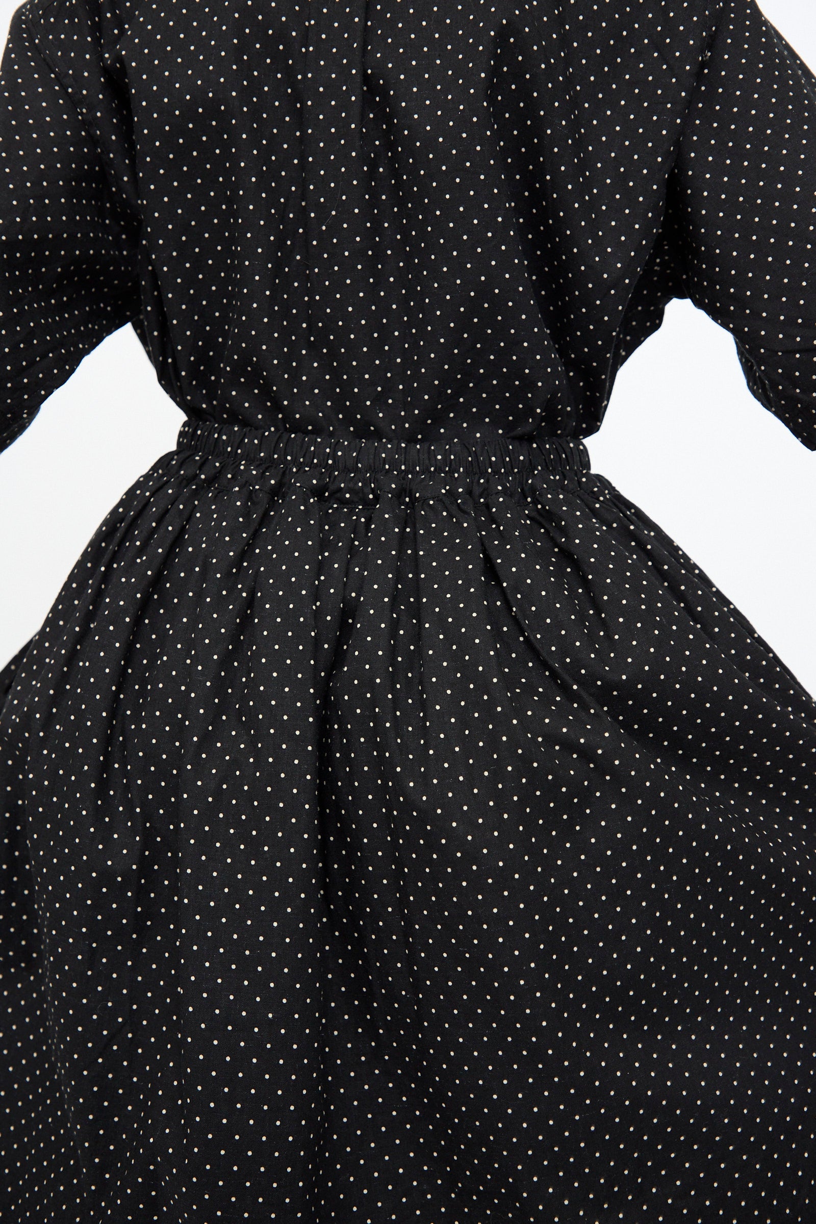 The Cotton Linen Dot Skirt in Black by Ichi Antiquités features white polka dots and a flowing silhouette, shown from the back with a gathered, elasticized waist.