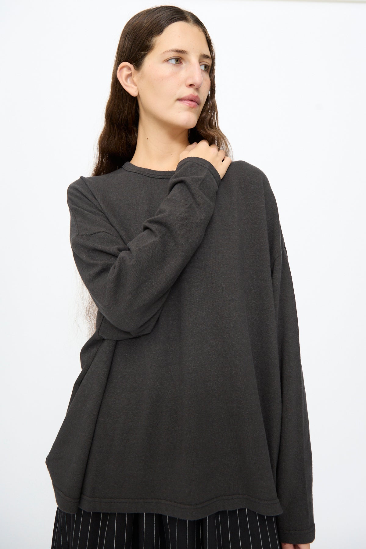 A woman wearing an Ichi Antiquités Cotton Loose Pullover in black, featuring a loose fit and a round neckline.