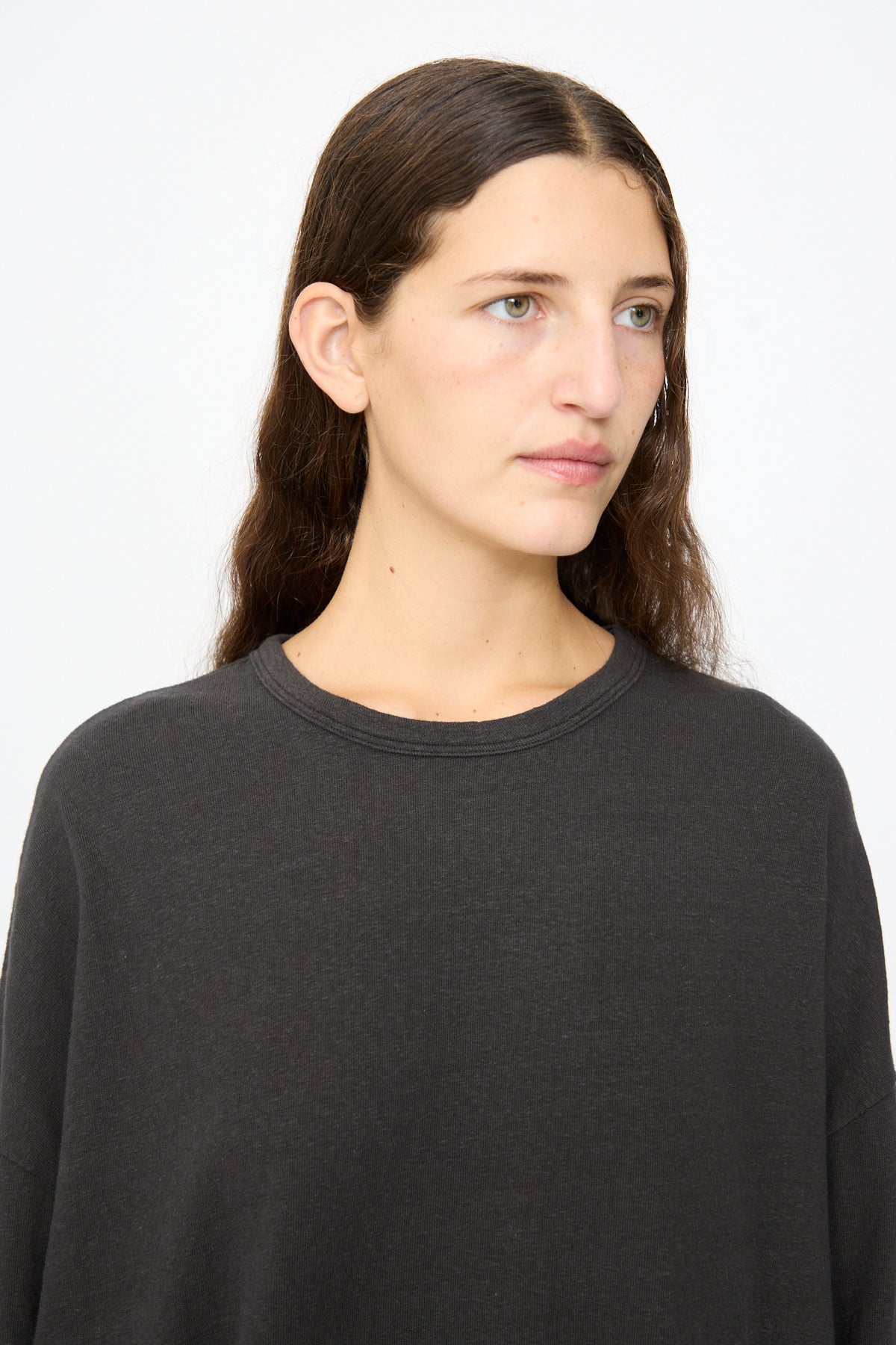 A person wearing an Ichi Antiquités Cotton Loose Pullover in black, a loose cotton crewneck with a relaxed fit.