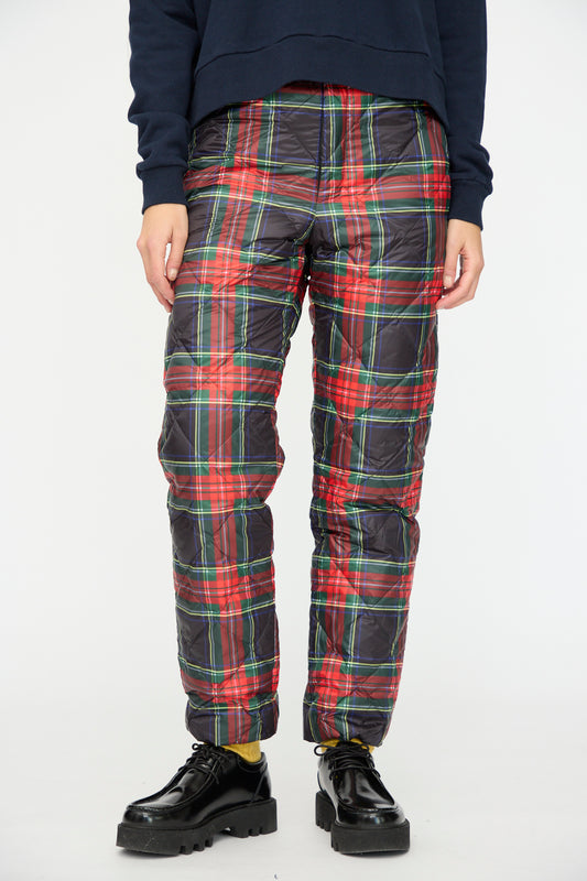 A person wears Ichi Antiquités Down Pants in Black Tartan with an elastic waist, a navy sweatshirt, yellow socks, and black platform shoes, standing against a plain white background.
