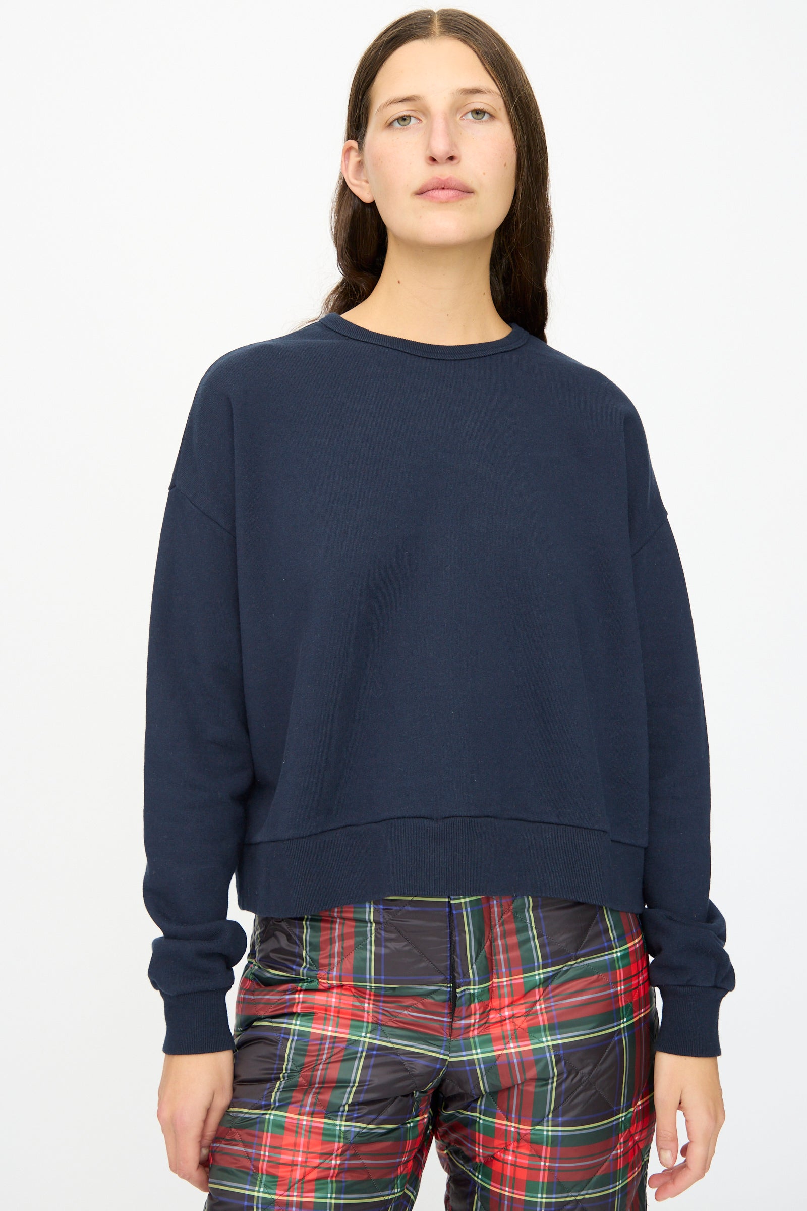 A person wears the Ichi Antiquités French Terry Cotton Pullover in Navy with red-green plaid pants, standing against a plain white background.