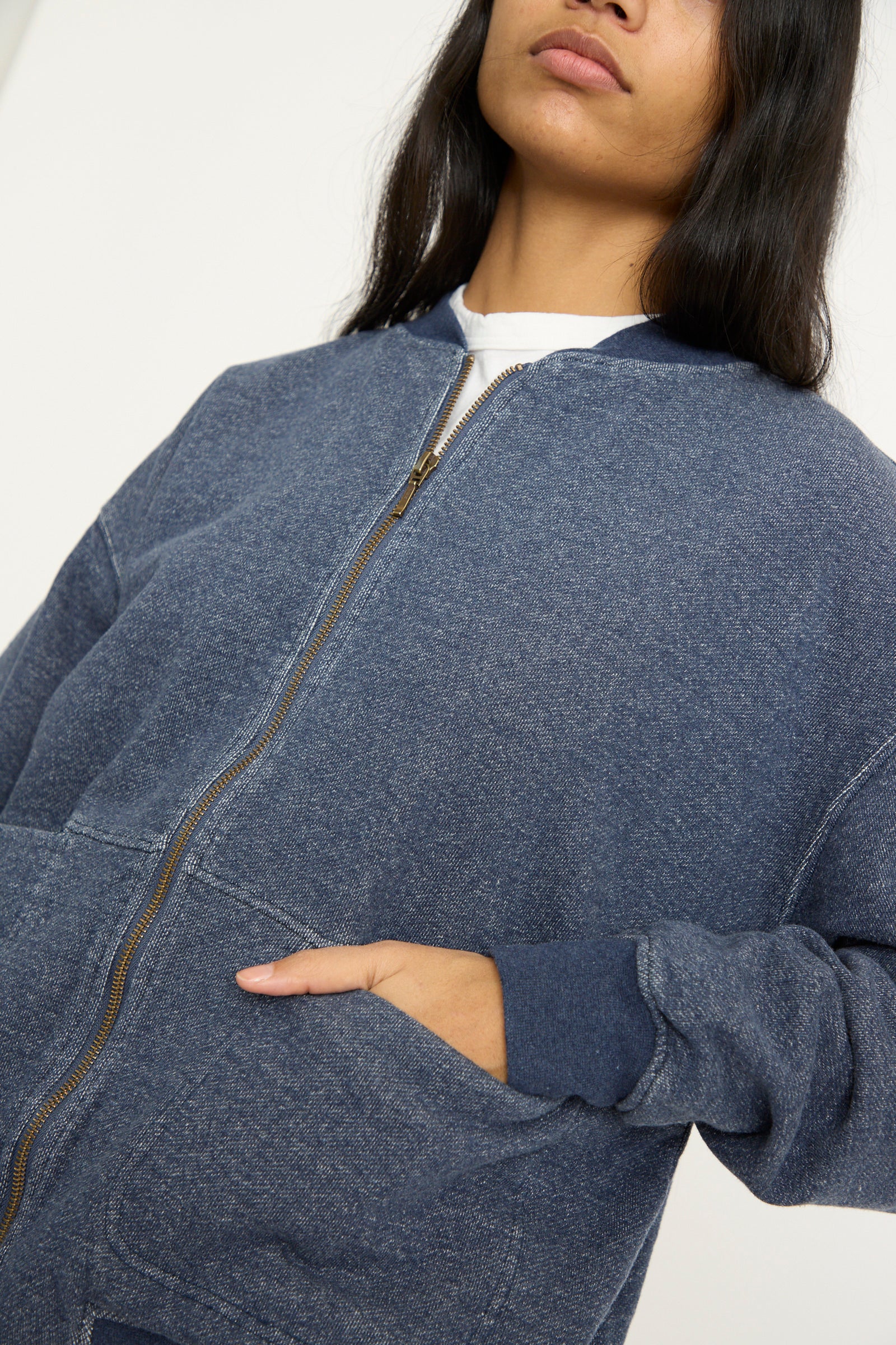 A person wearing the Ichi Antiquités French Terry Denim Blouson in Navy, with hands in front pockets, stands against a plain background.