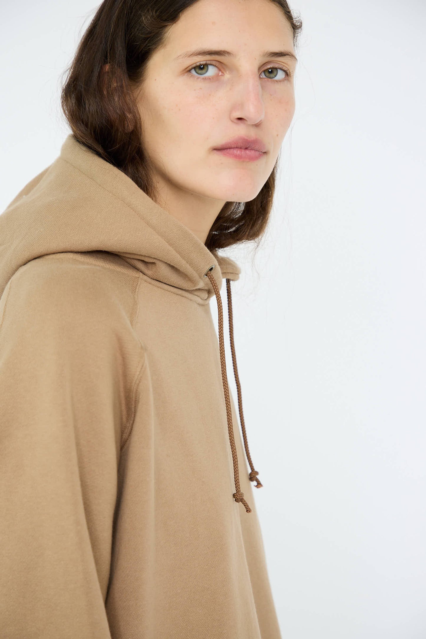 A person wears the French Terry Hoodie in Beige by Ichi Antiquités, standing against a plain background.