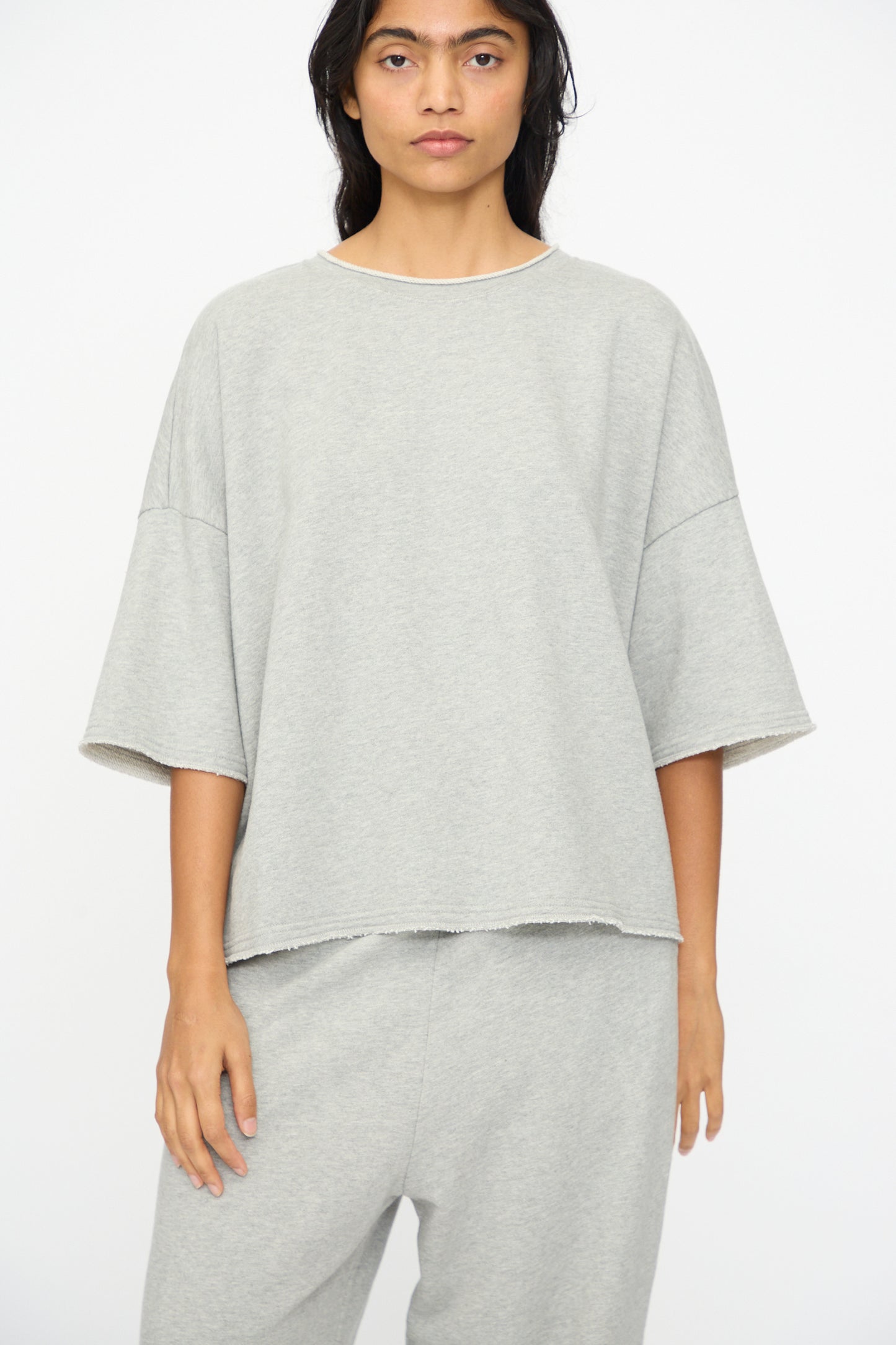 A person wears the Ichi Antiquités French Terry Pullover in gray, paired with matching pants, standing against a plain white background.