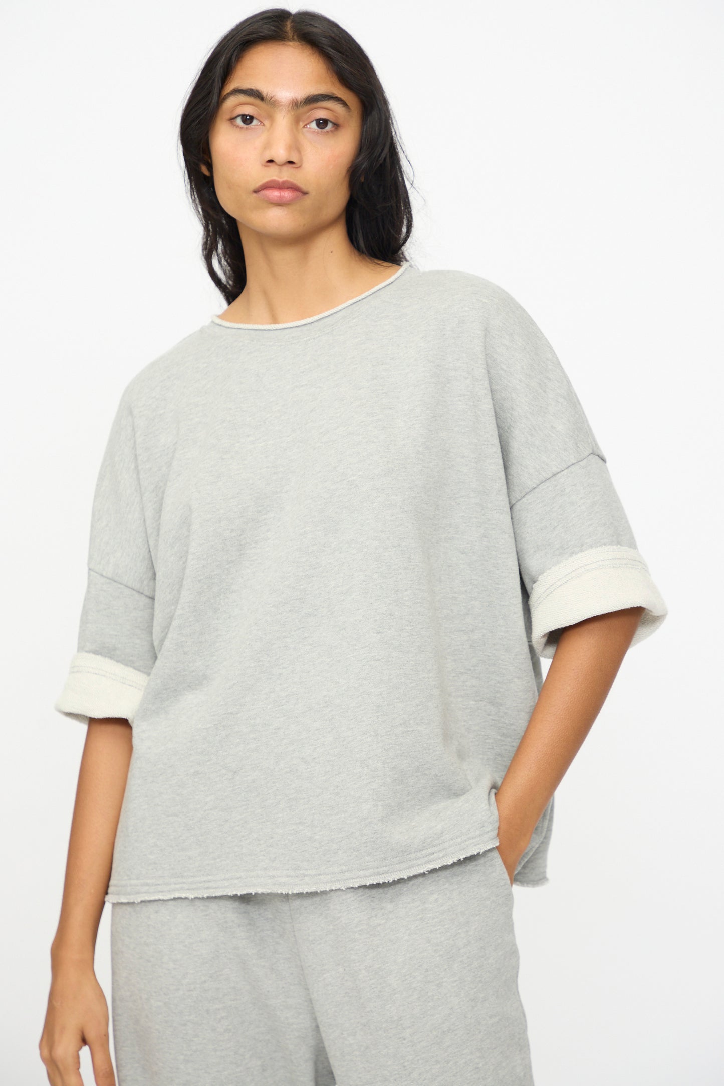 A person wears the Ichi Antiquités French Terry Pullover in Gray, a loose-fitting top with matching pants made in Japan, against a plain white background.