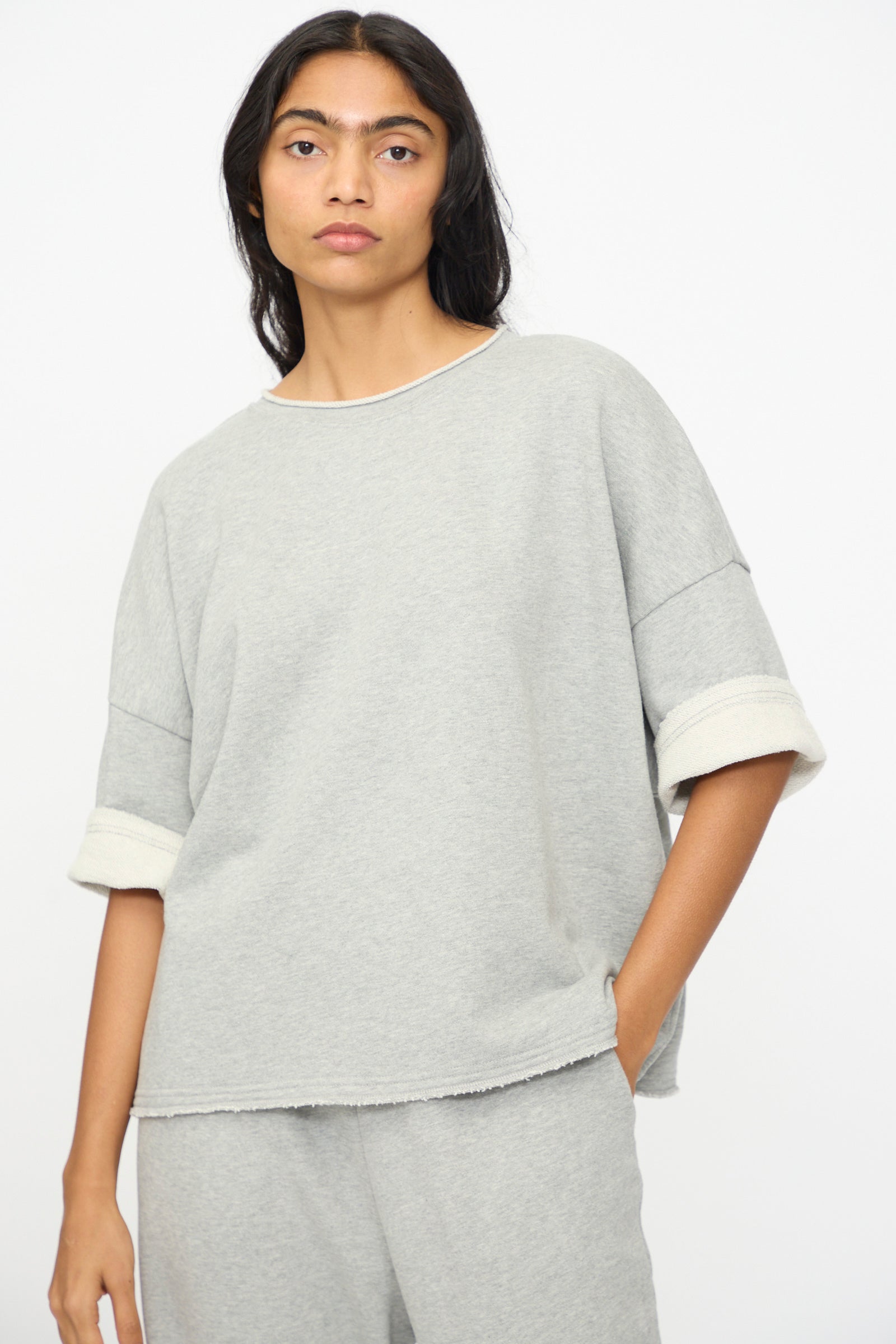 A person wears the Ichi Antiquités French Terry Pullover in Gray, a loose-fitting top with matching pants made in Japan, against a plain white background.