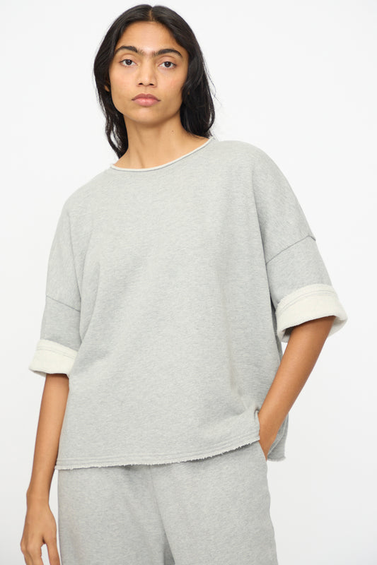 A person wears the Ichi Antiquités French Terry Pullover in Gray, a loose-fitting top with matching pants made in Japan, against a plain white background.