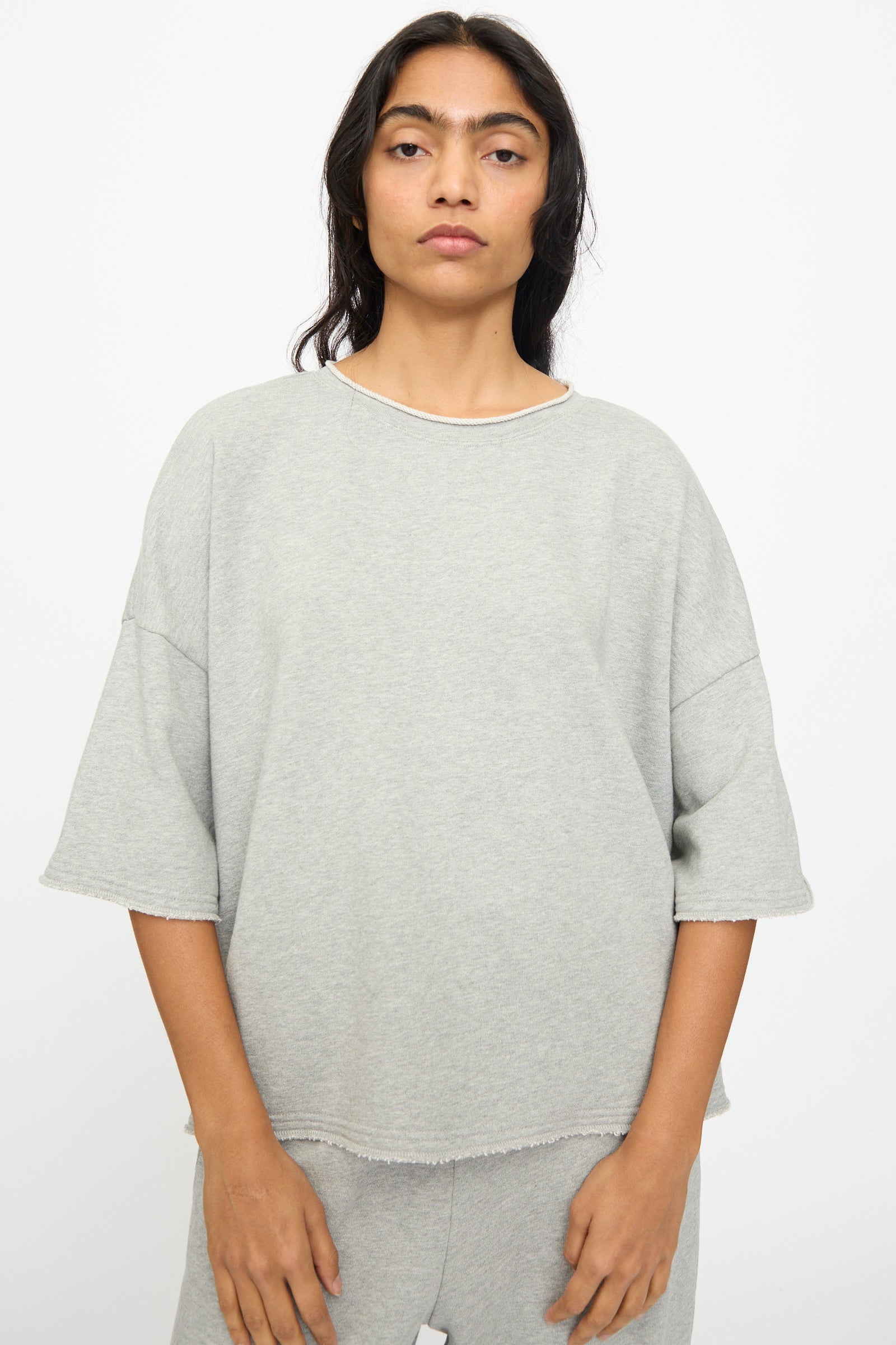 A person stands against a plain background, wearing the Ichi Antiquités French Terry Pullover in Gray, looking directly at the camera with a neutral expression.