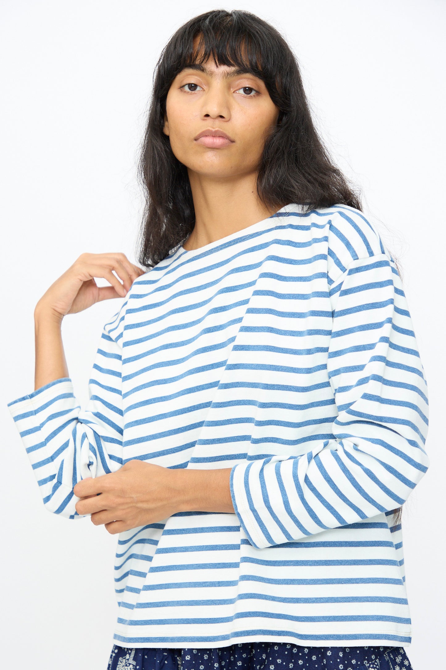 A person with long dark hair wears the Indigo Pullover Tee in White and Blue by Ichi Antiquités, posing against a plain light background.