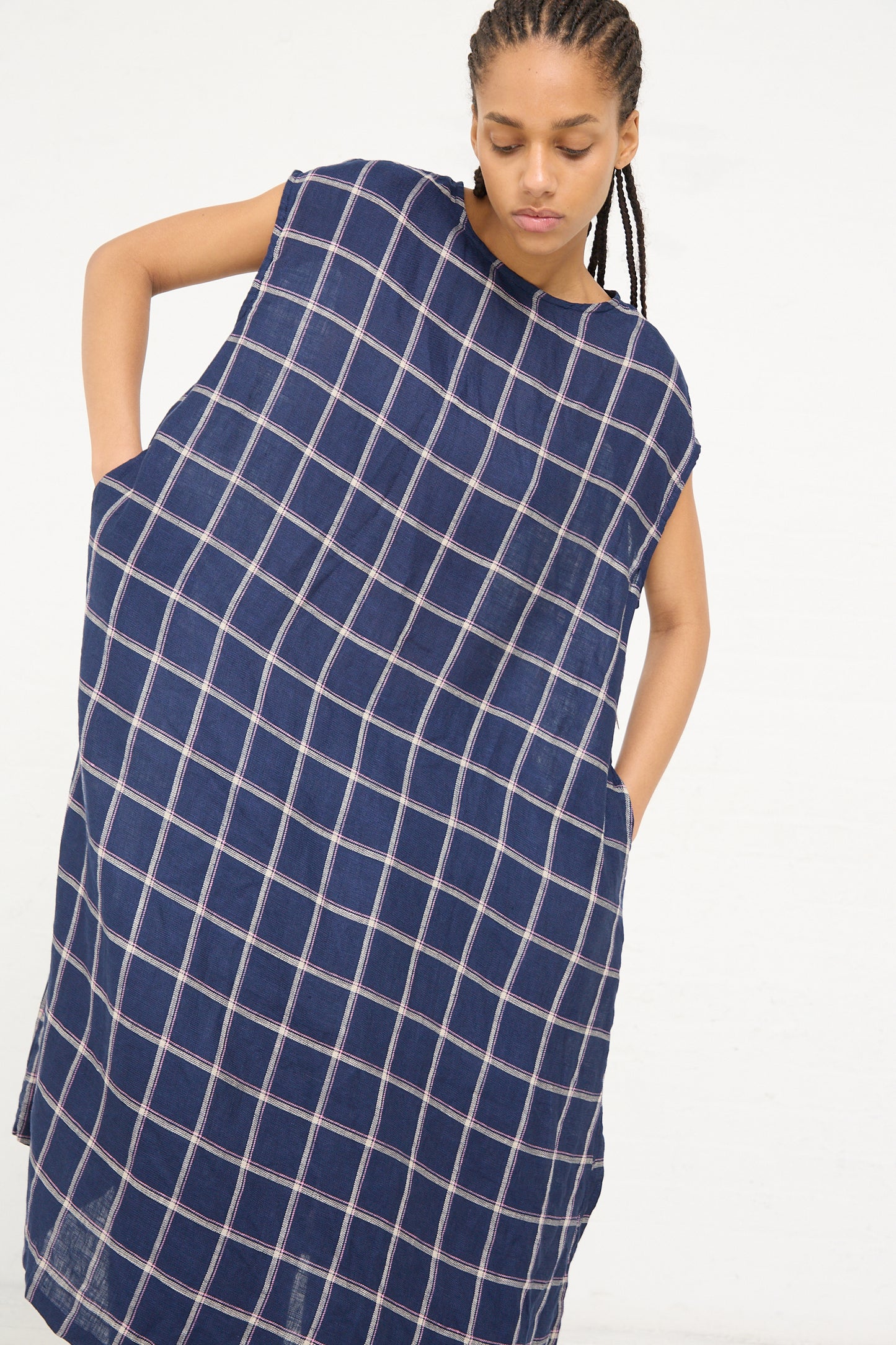 A woman in a Linen Check Dress in Navy by Ichi Antiquités posing with her hand on her hip.