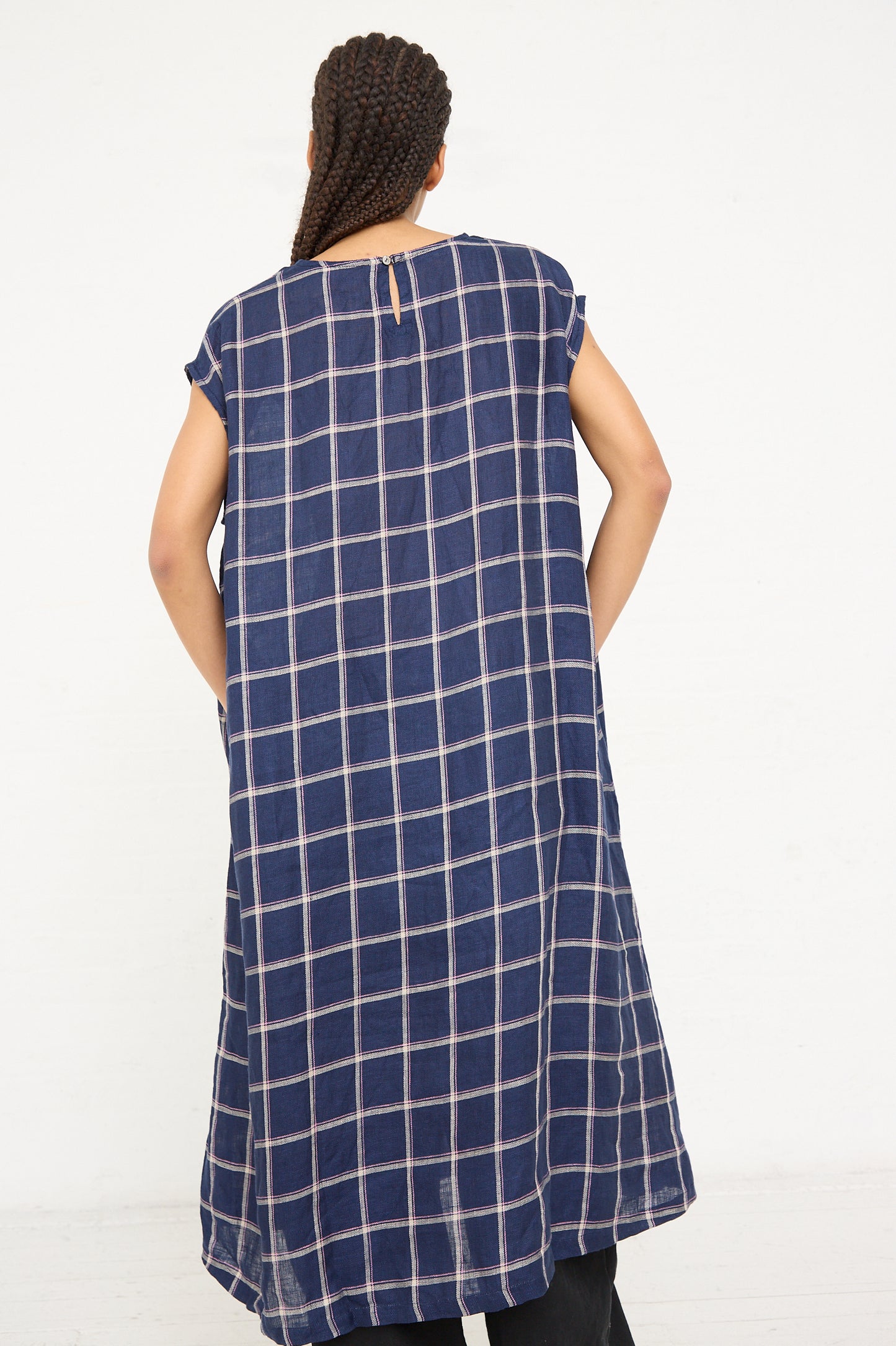 A person seen from behind wearing a long, sleeveless, Linen Check Dress in Navy with a simple neckline from Ichi Antiquités.