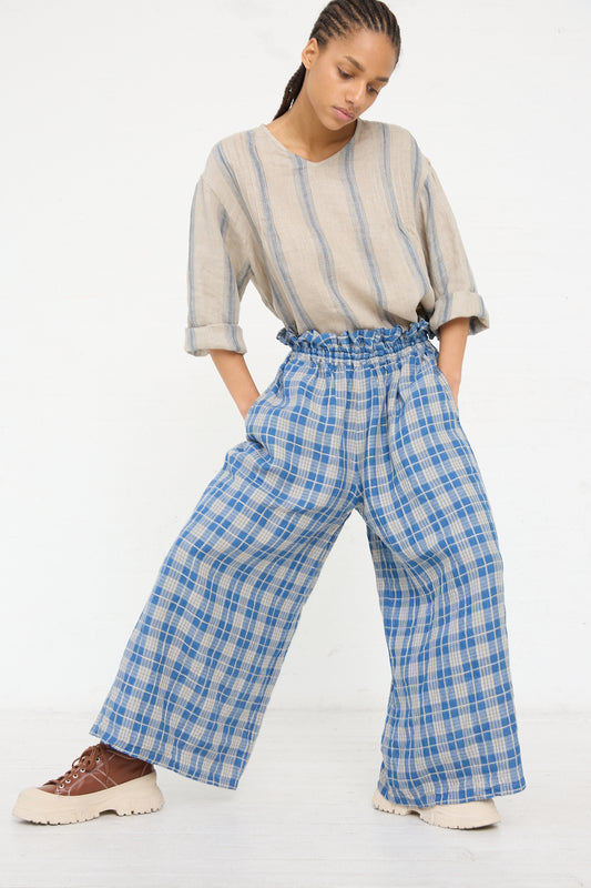 Woman in a striped top and Ichi Antiquités Linen Check Pant in Light Indigo and Natural standing against a white background.
