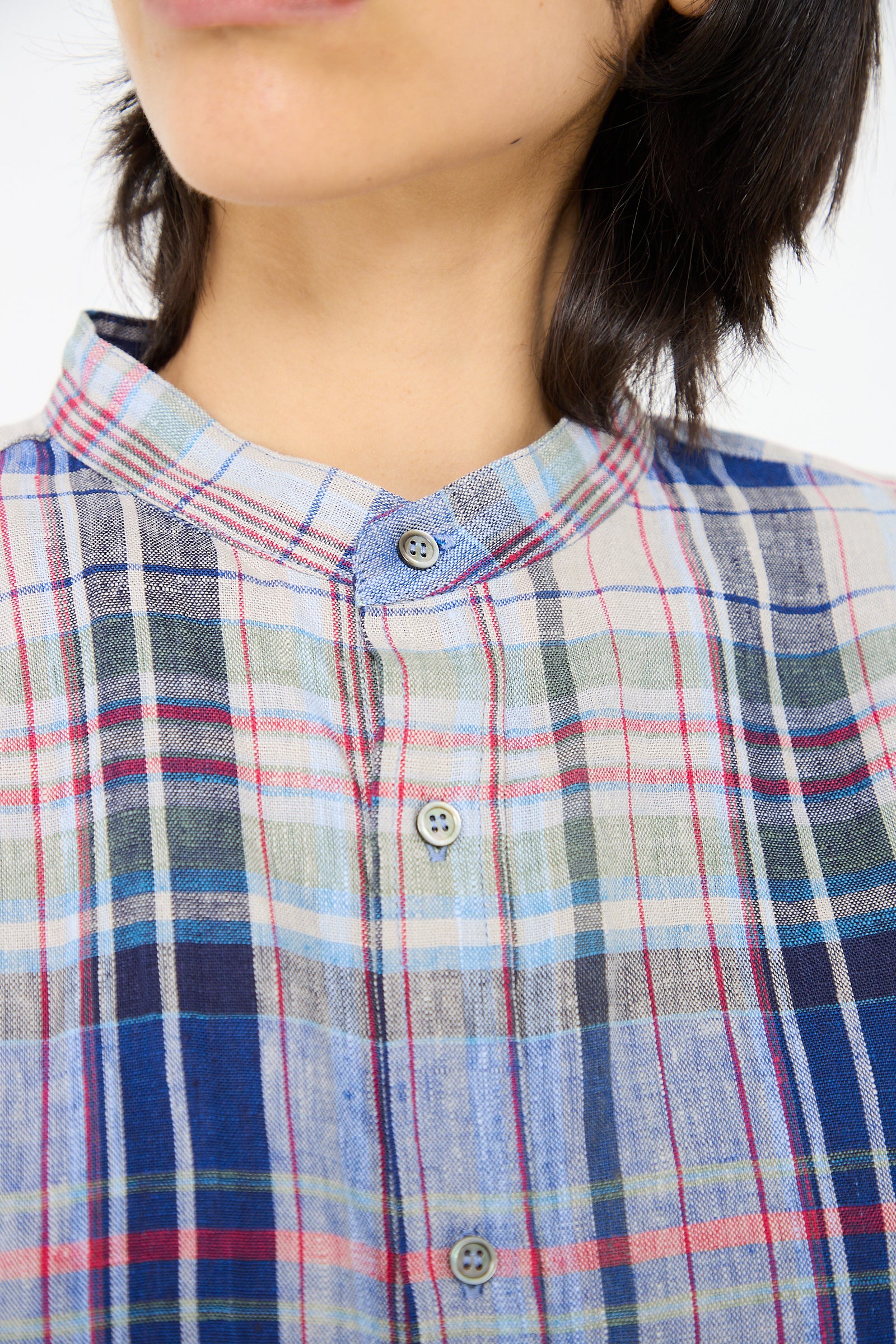 Person wearing a Linen Check Shirt in Navy by Ichi Antiquités, photographed from the neck down.