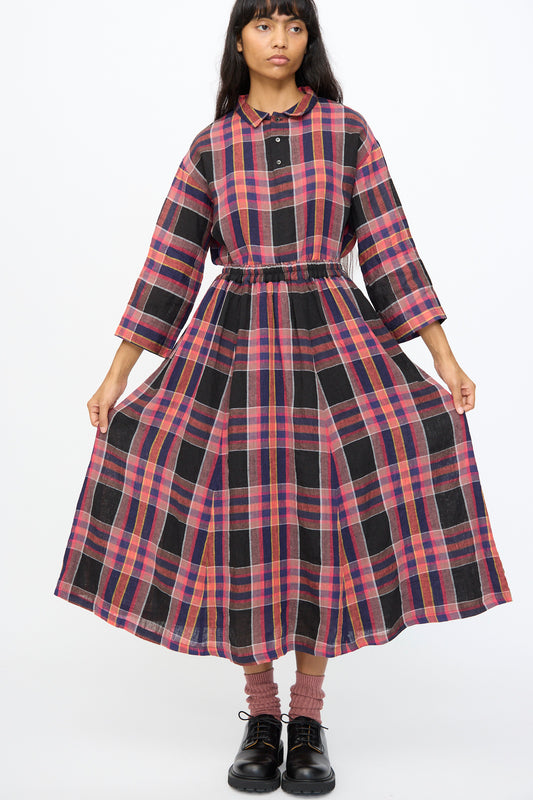 A person wearing the Ichi Antiquités Linen Check Skirt in Black with black shoes and pink socks, standing against a plain white background.