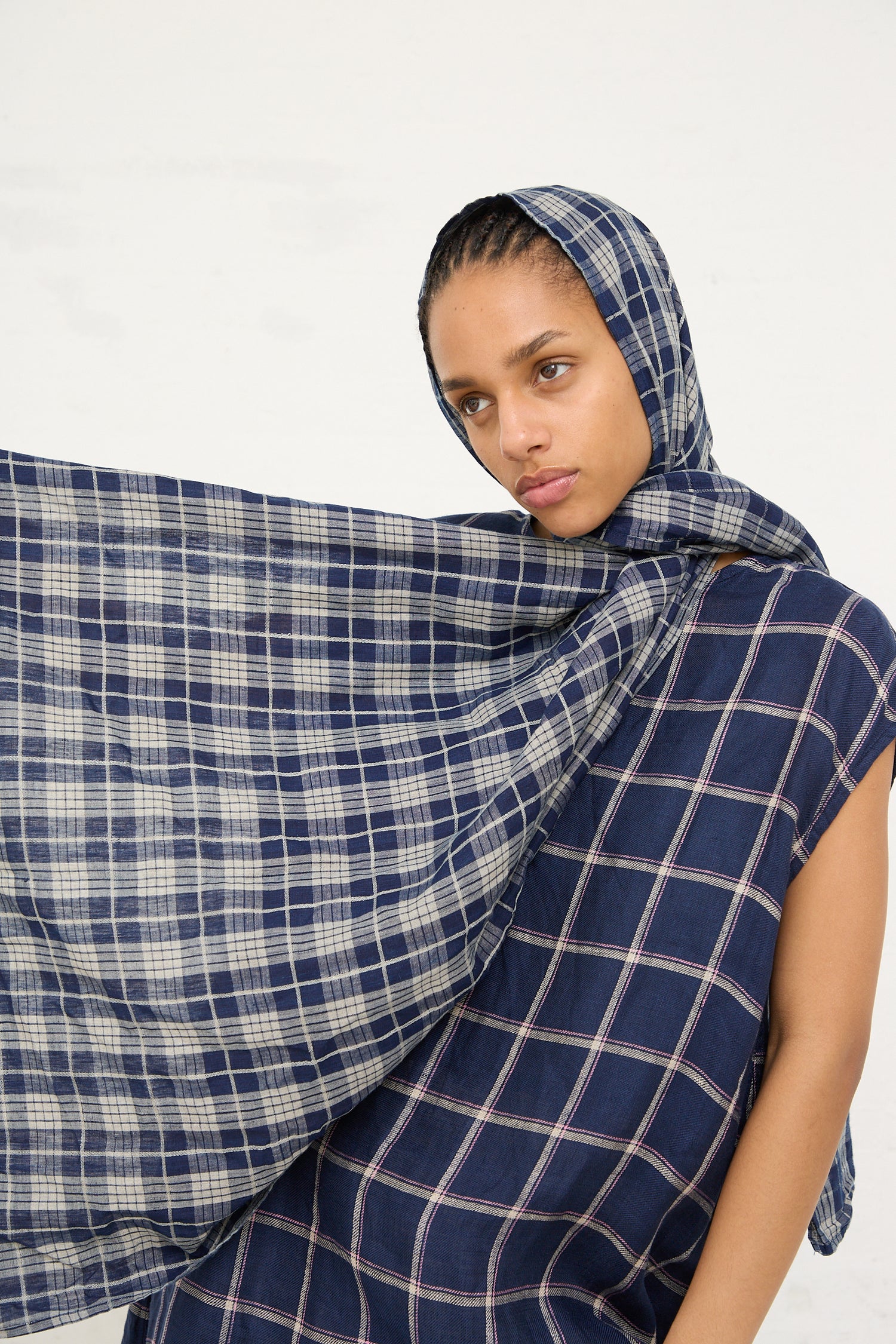 Woman draped in a Linen Check Stole in Dark Indigo and Natural from Ichi Antiquités against a white background.