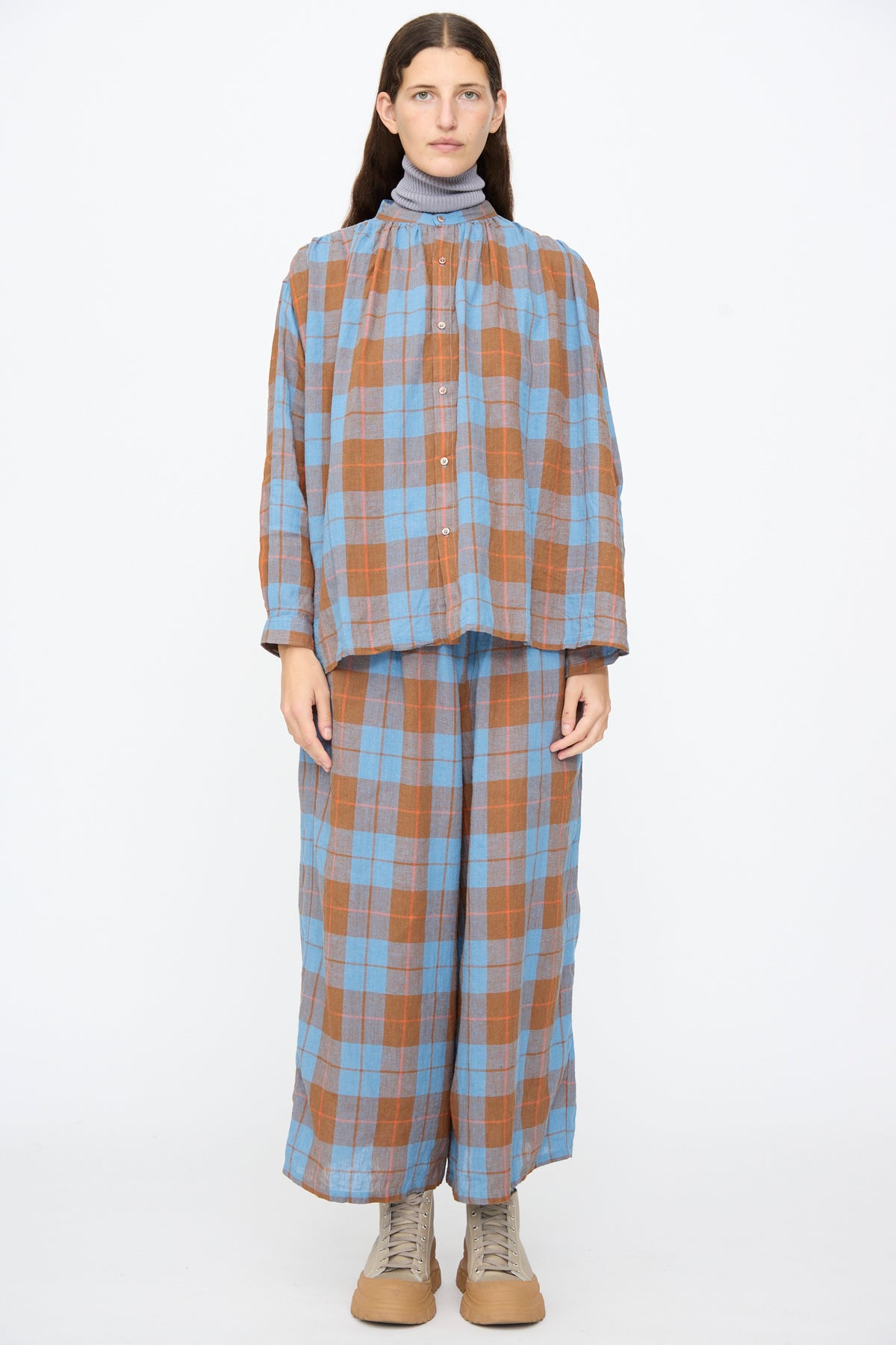 Model wearing an Ichi Antiquités Linen Cotton Check Shirt in Blue and matching wide-leg trousers over a grey mock-neck top.