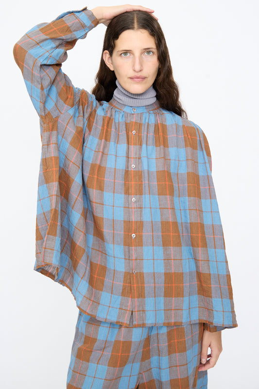 A person wearing an Ichi Antiquités Linen Cotton Check Shirt in Blue over a grey turtleneck.