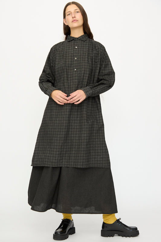 Model wears the Ichi Antiquités Linen Cotton Gingham Sumi Shirt in Pin Check over a matching skirt, paired with yellow socks and black shoes, against a plain white background.