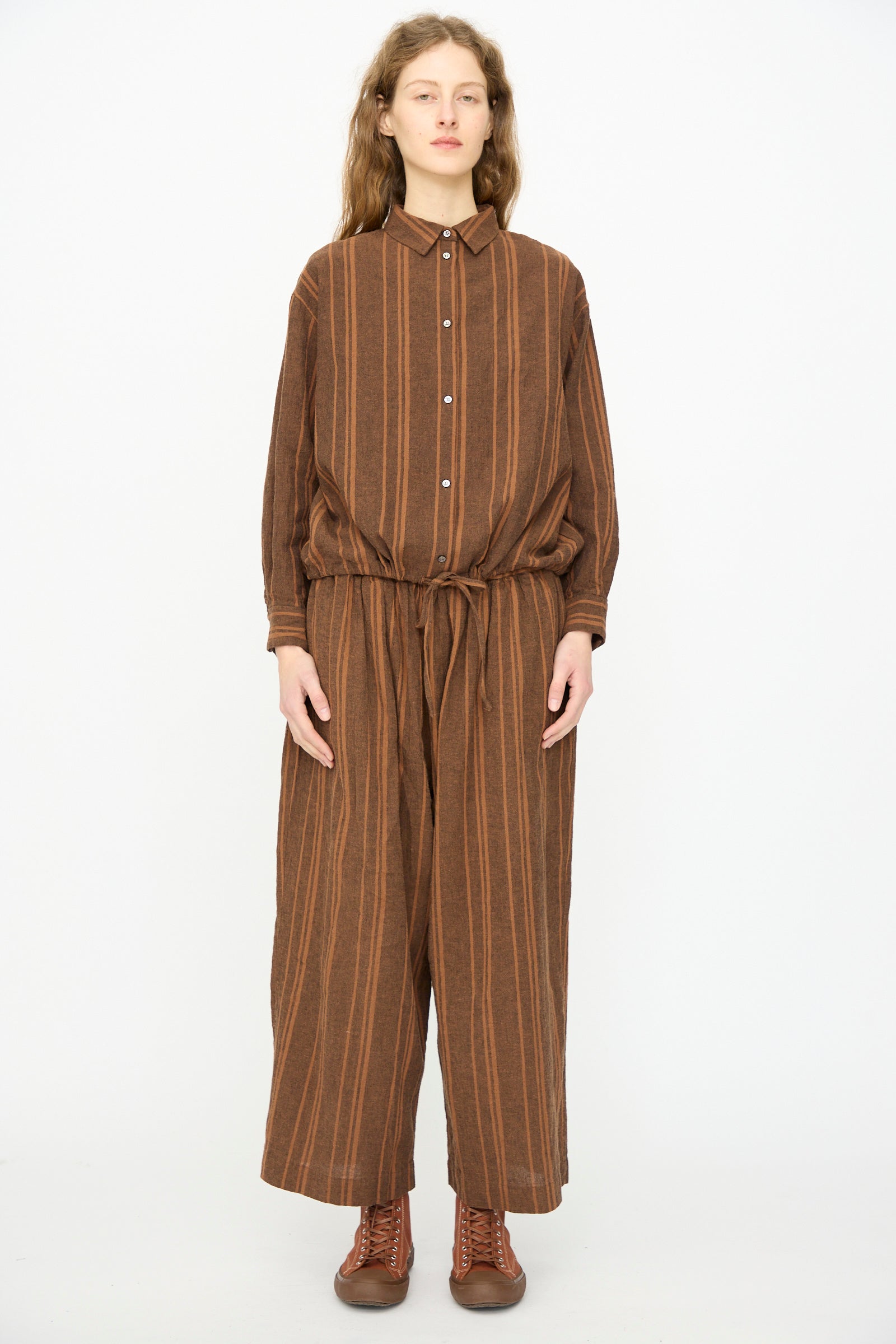 A person wears the Ichi Antiquités Linen Cotton Random Stripe Shirt in Brown against a plain background, styled with matching wide-leg pants and brown lace-up shoes.