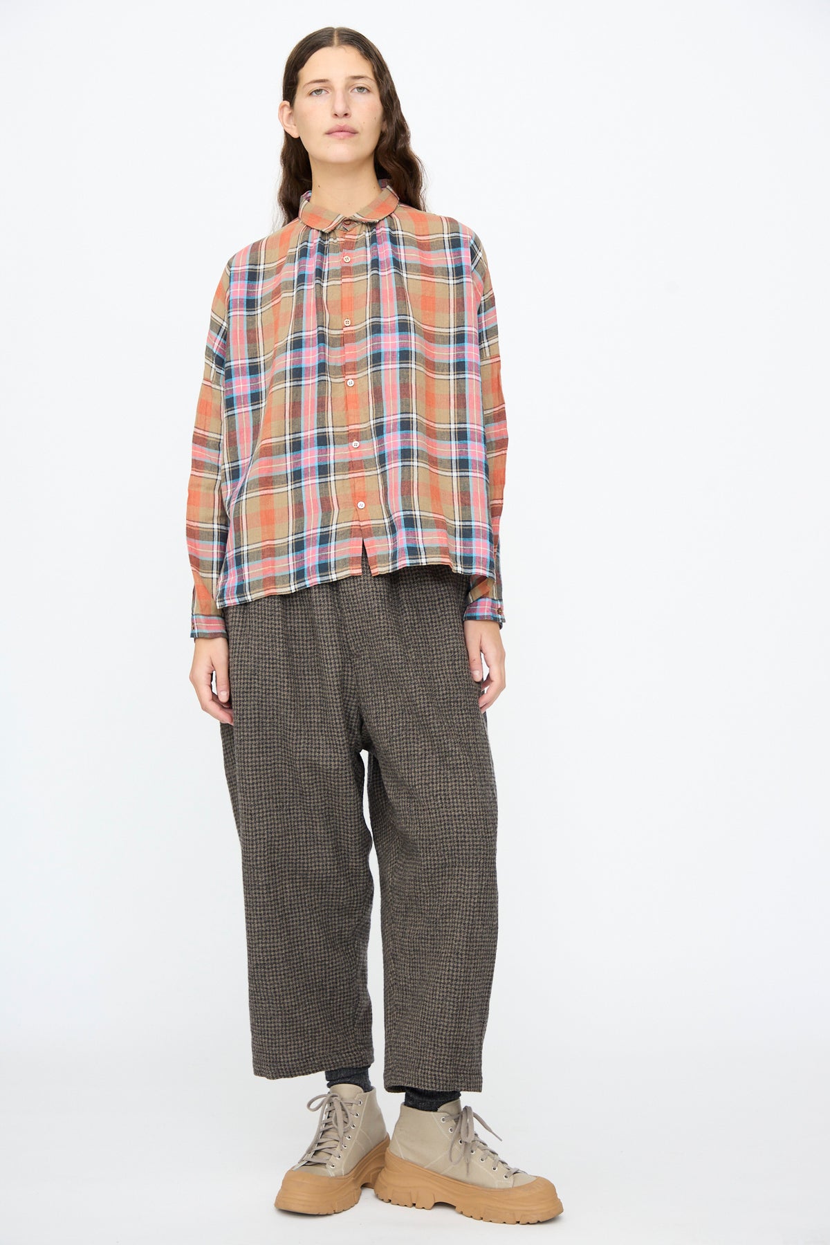 A person wears an Ichi Antiquités Linen Cotton Tartan Check Shirt in Beige, dark gray wide-leg trousers, and tan lace-up ankle boots with thick rubber soles.