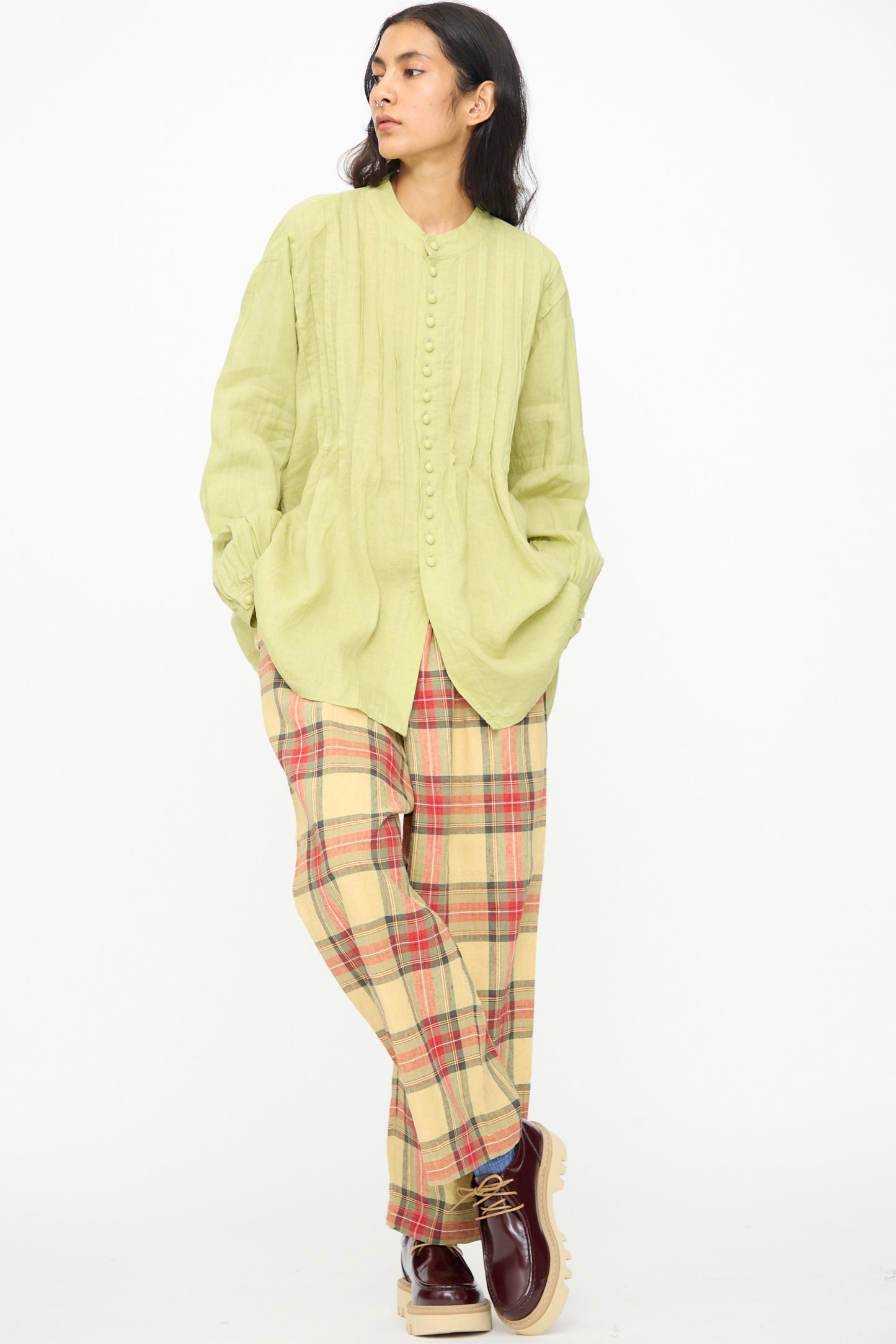 A person wearing Ichi Antiquités Linen Cotton Tartan Pants in Butter Yellow stands against a plain white background.
