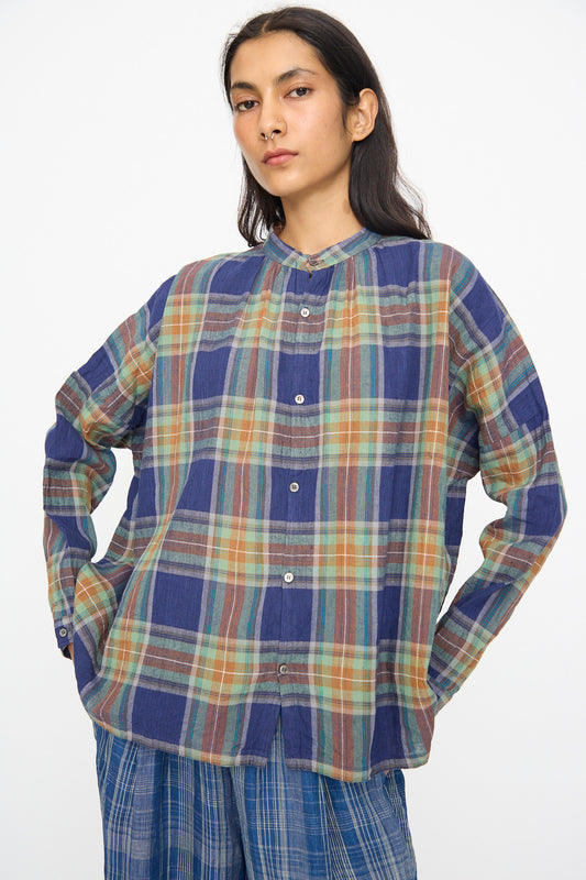 Model wears the Ichi Antiquités Linen Cotton Tartan Shirt in Navy, featuring a relaxed fit and navy tartan pattern, paired with blue plaid pants against a plain white background.