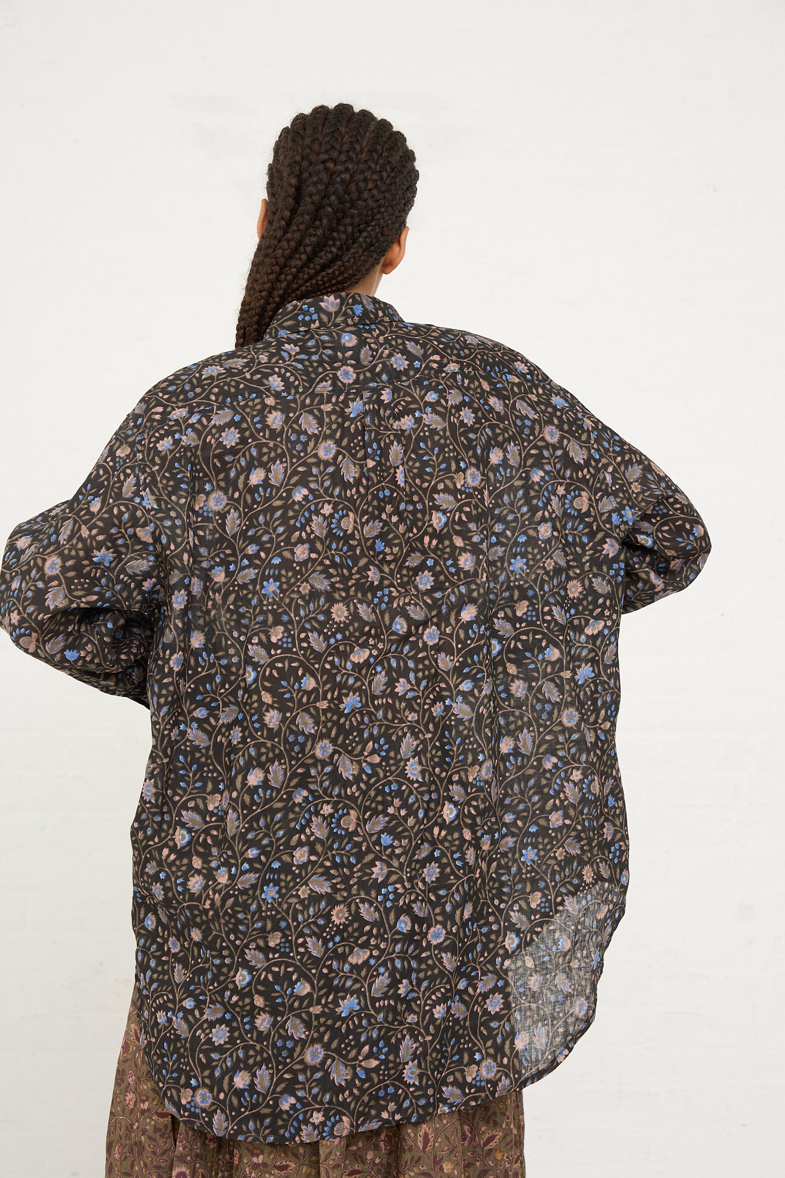 Rear view of a person wearing an Ichi Antiquités Linen Floral Shirt in Black with a braided hairstyle.