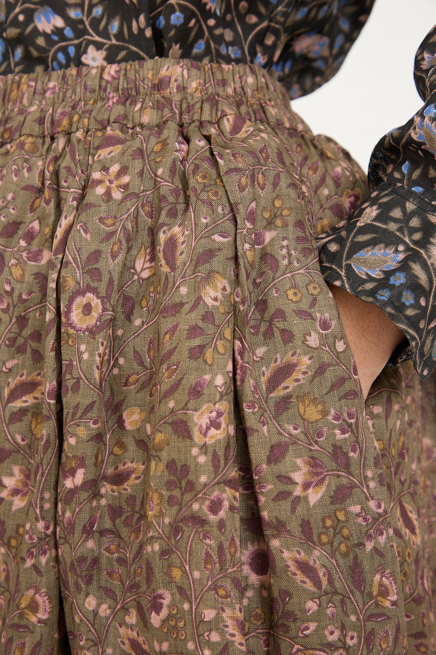 Close-up of a linen floral skirt in mocha with puff sleeves and gathered detailing by Ichi Antiquités.
