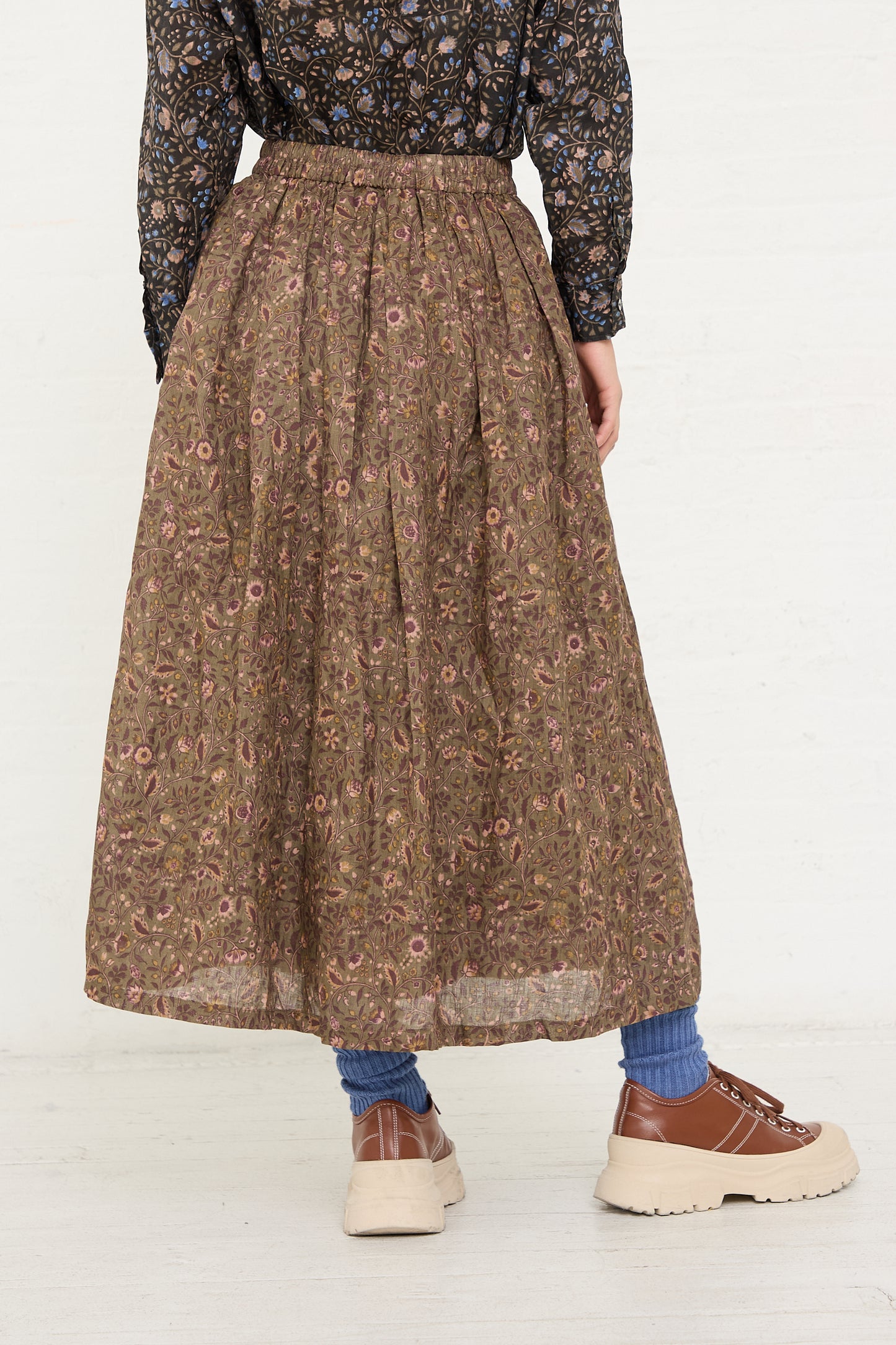Woman wearing an Ichi Antiquités Linen Floral Skirt in Mocha with a lace top, patterned socks, and chunky sole shoes.