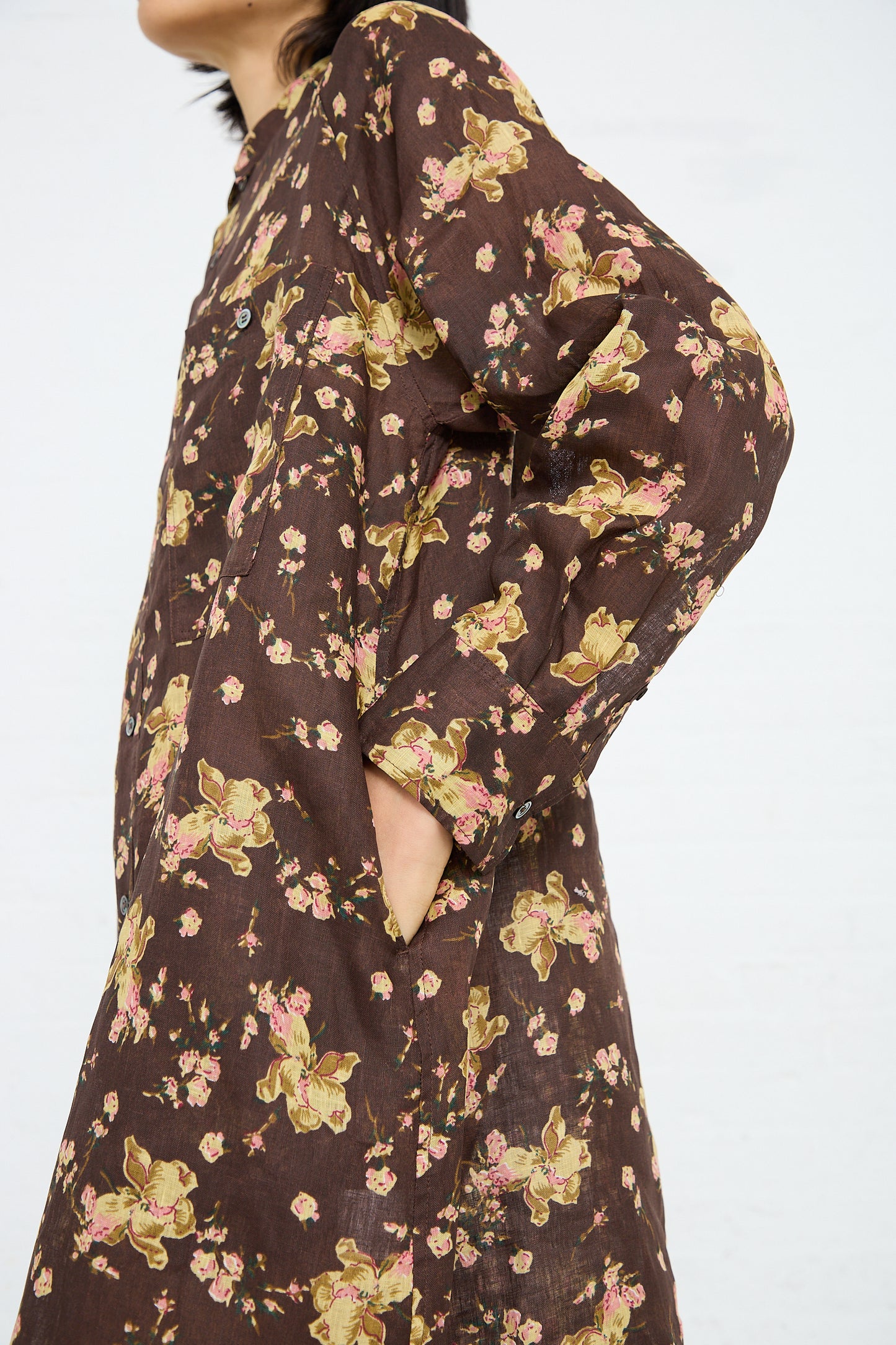 Person wearing an Ichi Antiquités Linen Flower Print Dress in Brown with hands in pockets, shown from shoulder to mid-thigh.