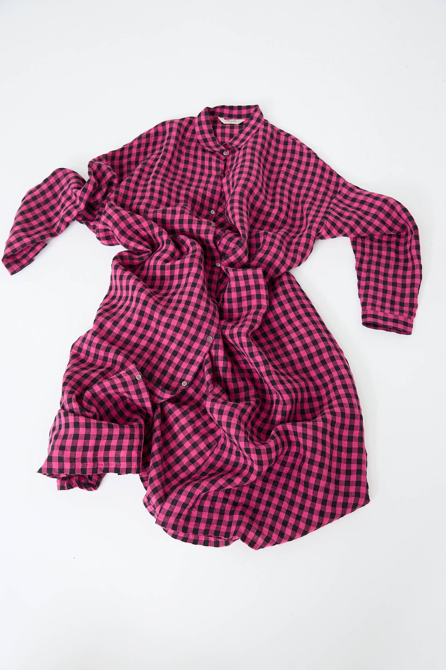 A crumpled, long-sleeve dress by Ichi Antiquités featuring a pink and black gingham check pattern on a white background.