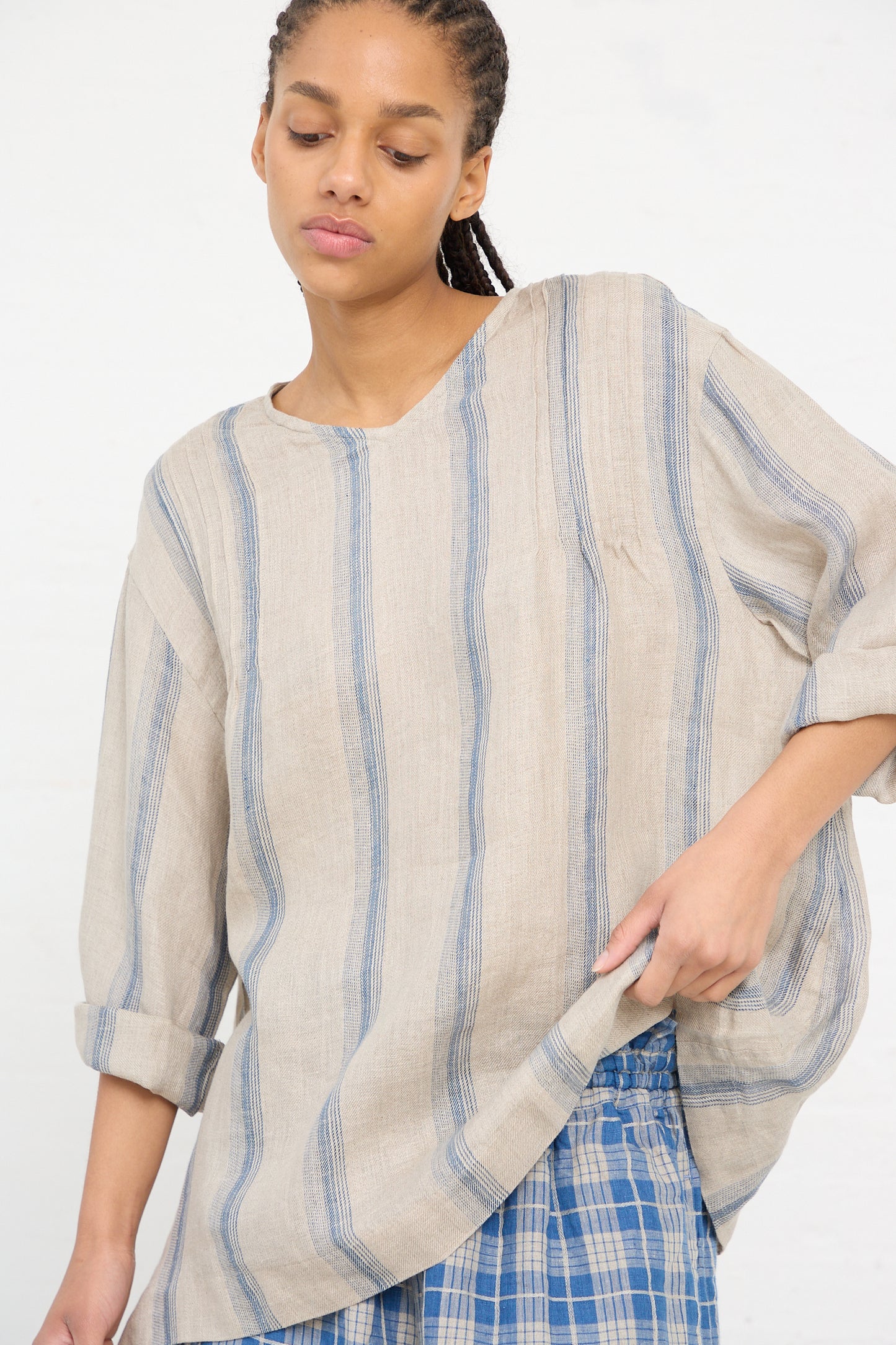Woman in a Linen Stripe Pullover in Natural and Indigo by Ichi Antiquités standing with one hand in her pocket.