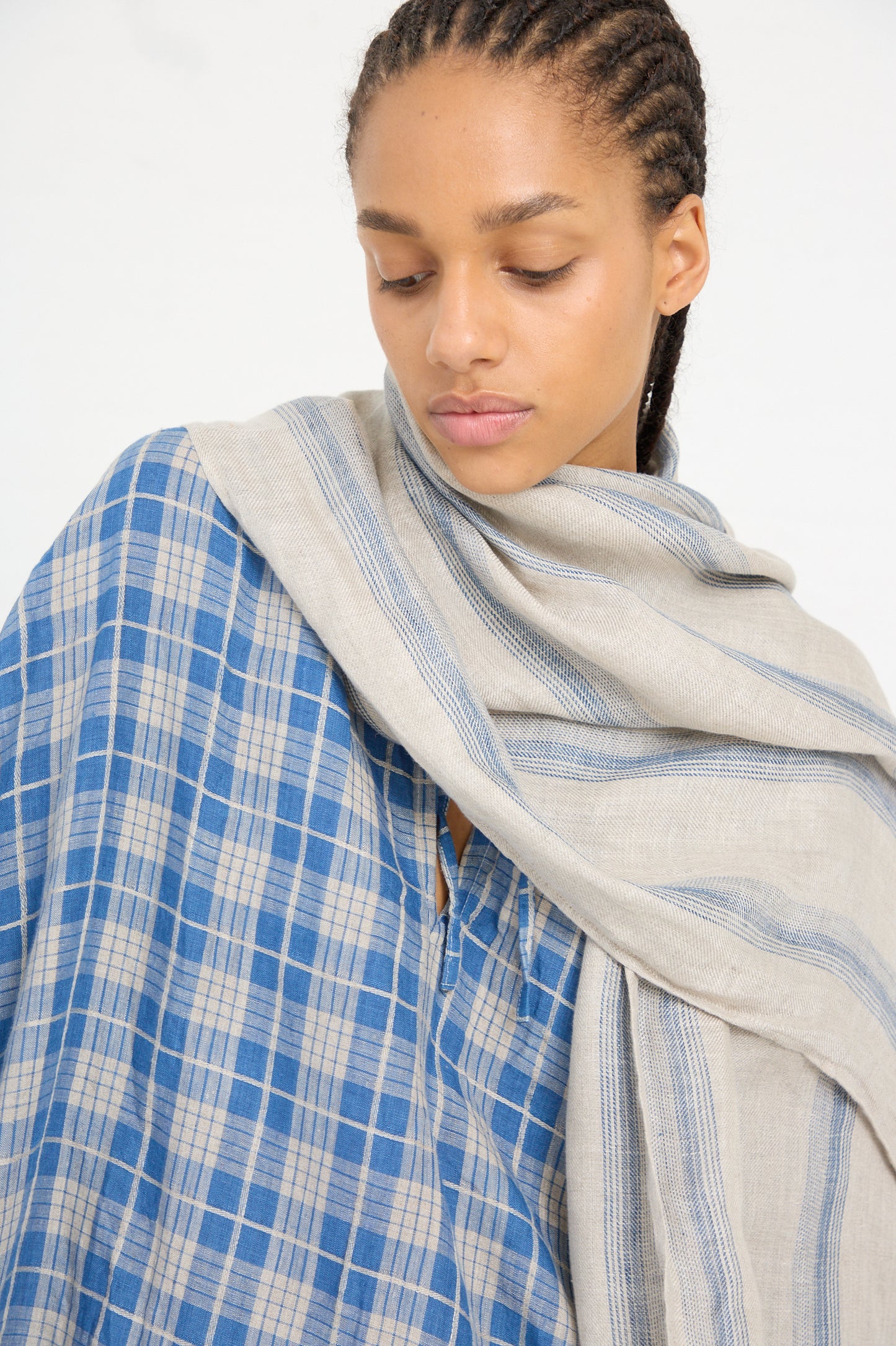 Woman with an Ichi Antiquités Linen Stripe Stole in Natural and Indigo draped over her shoulder.