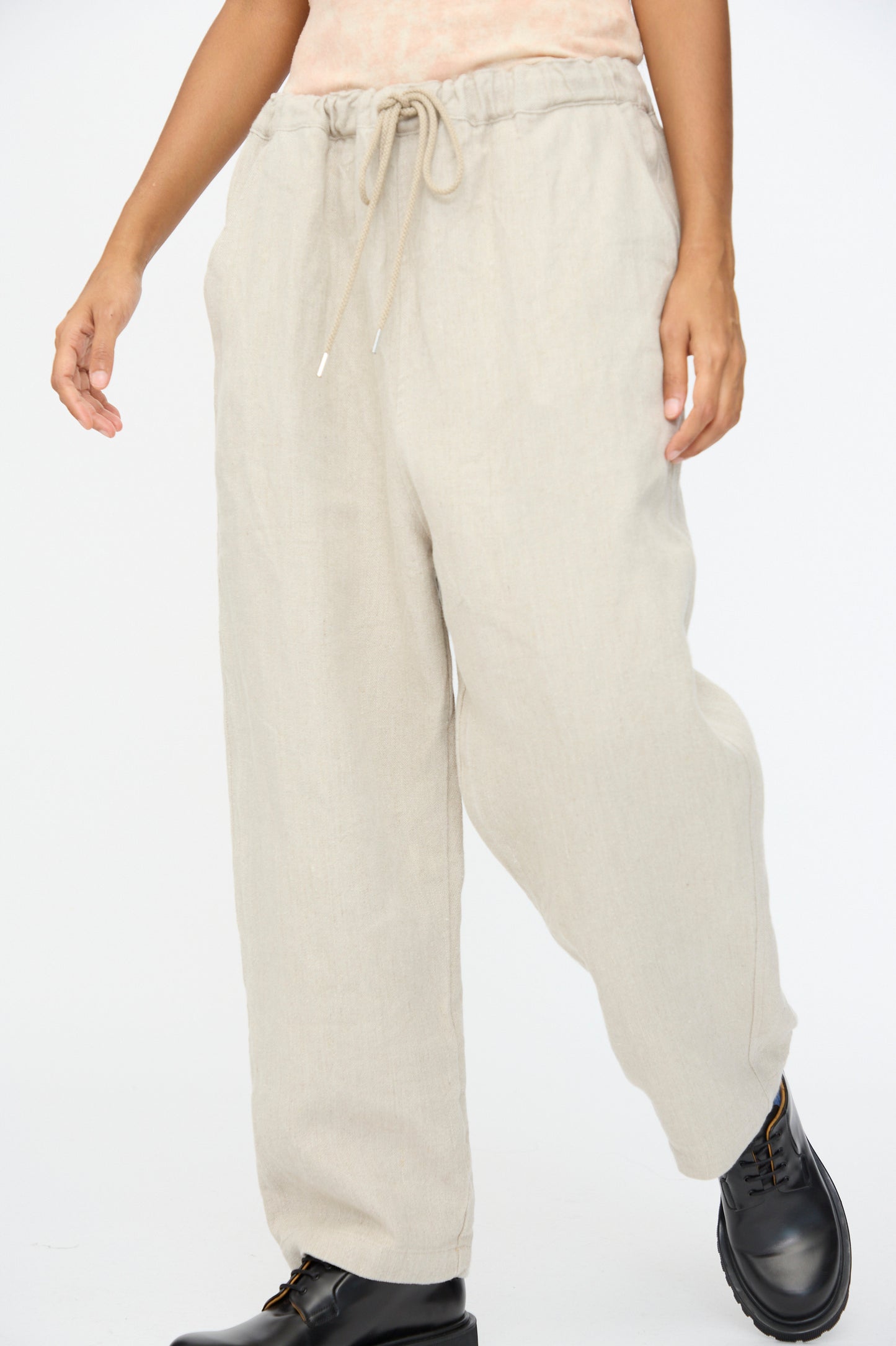 Someone wears the Ichi Antiquités Twill Weave Linen Pant in Natural, styled with black lace-up boots.