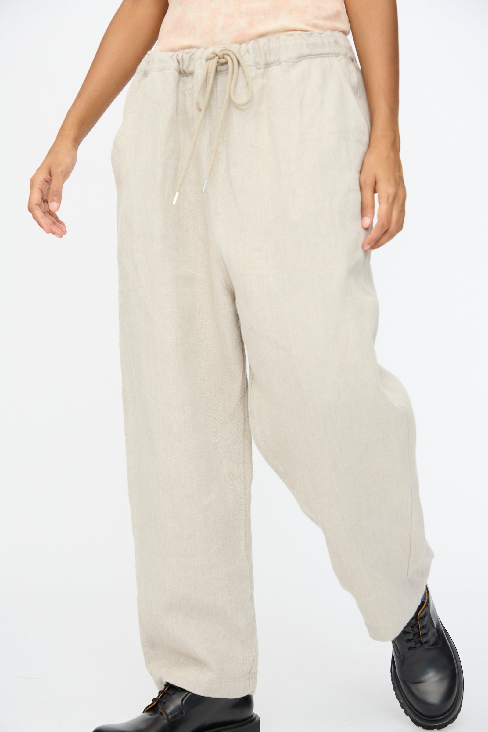 Someone wears the Ichi Antiquités Twill Weave Linen Pant in Natural, styled with black lace-up boots.