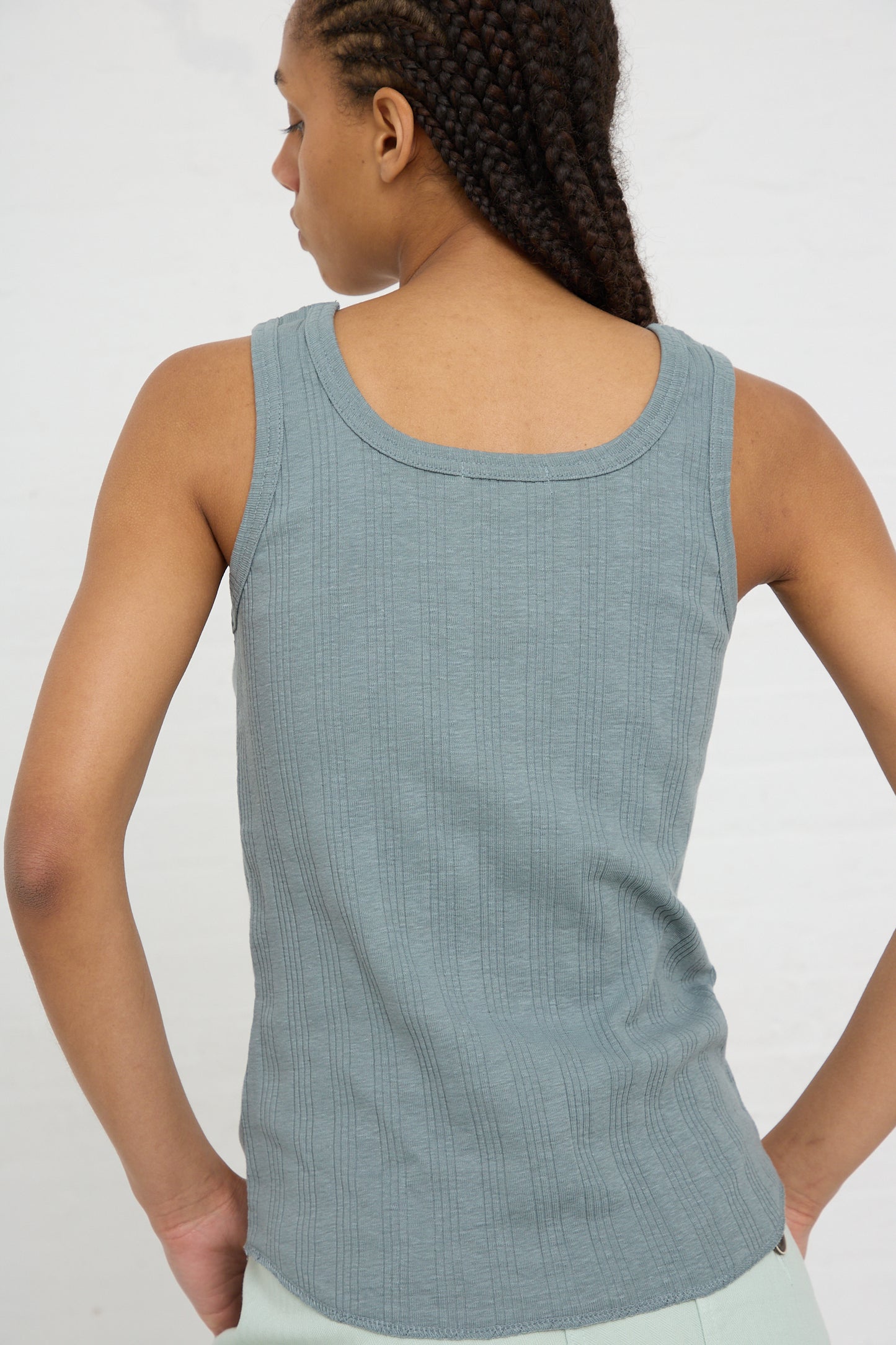 Woman wearing a Vintage Cotton Stripe Tank in Grayish Blue by Ichi Antiquités standing with her back to the camera.