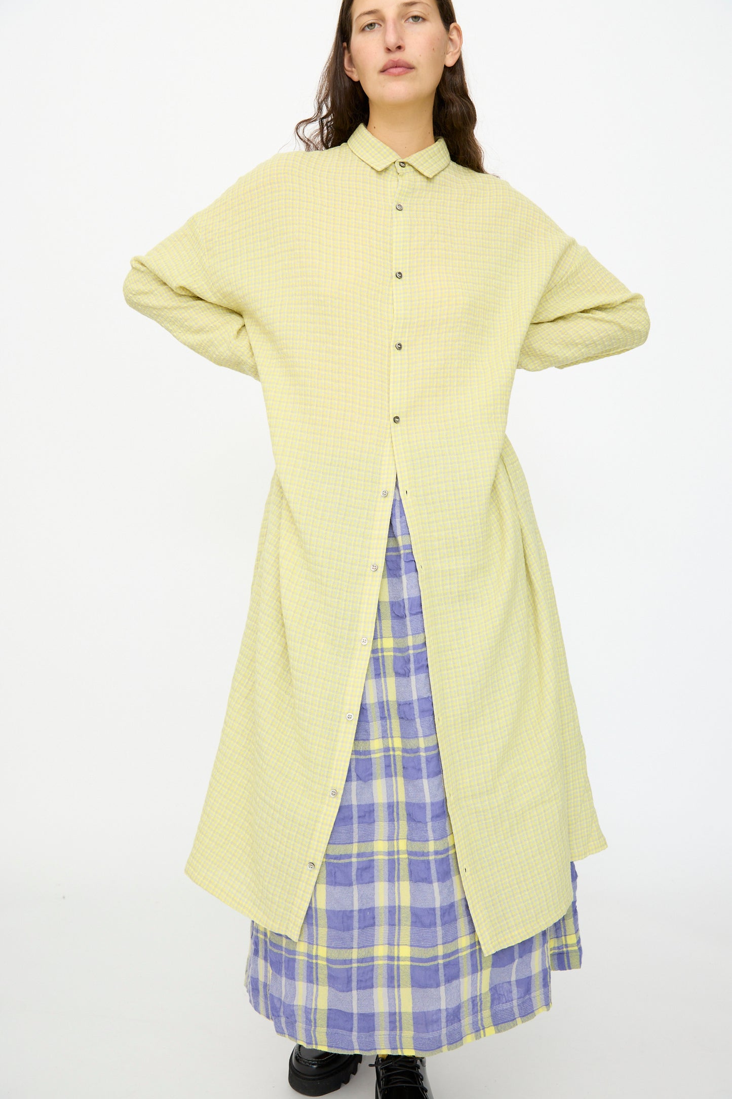 A person wears the Ichi Antiquités Wool Cotton Gingham Dress in Yellow and Gray, featuring an oversized silhouette, standing against a plain white background.