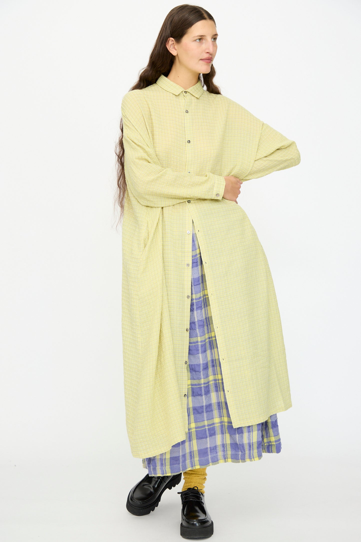 A person wears the Ichi Antiquités Wool Cotton Gingham Dress in Yellow and Gray, paired with yellow socks and black shoes, standing against a plain white background.