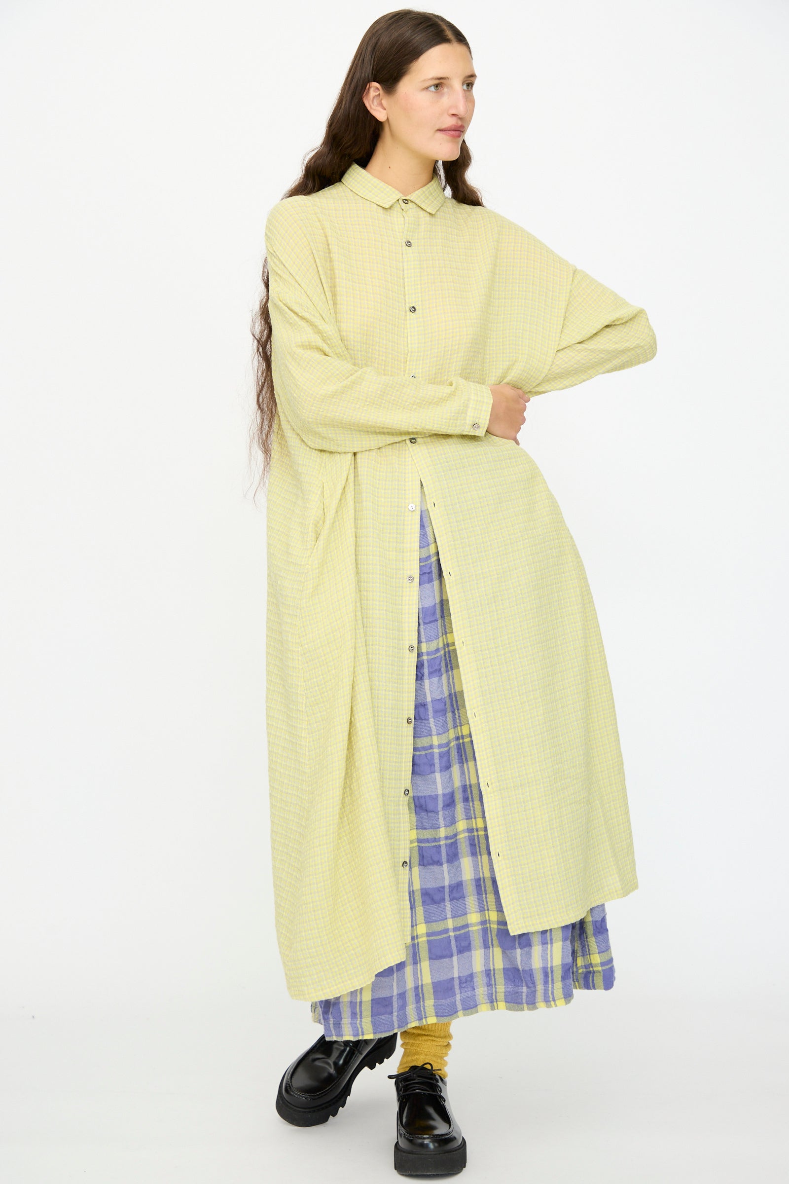 A person wears the Ichi Antiquités Wool Cotton Gingham Dress in Yellow and Gray, paired with yellow socks and black shoes, standing against a plain white background.