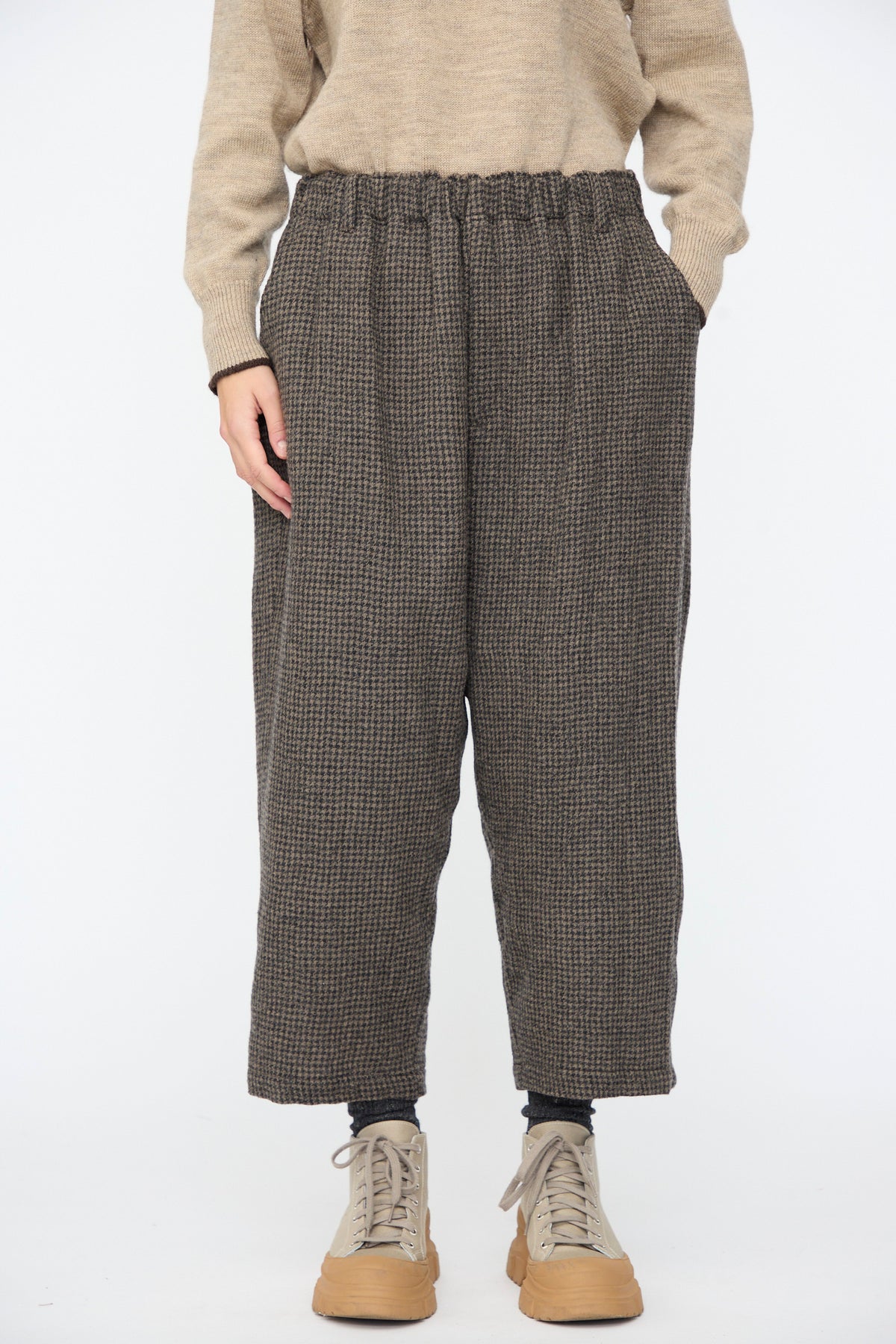 Relaxed-fit Wool Gauze Houndstooth Pants in Mocha with an elastic waist, worn with a tan sweater and light brown sneakers.